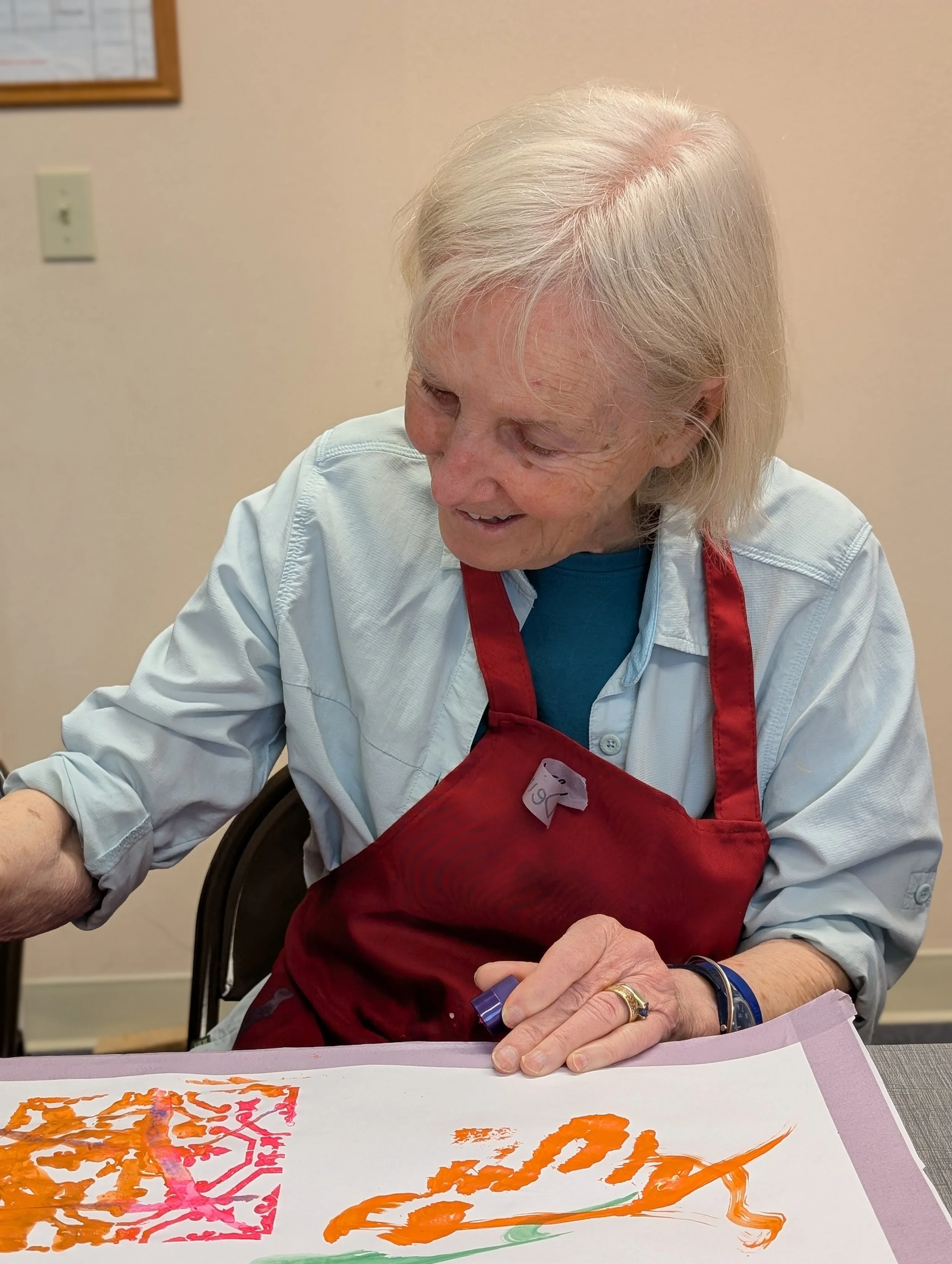 smiling woman who is painting