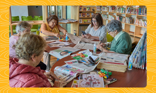Group of 5 people doing crafts at a table