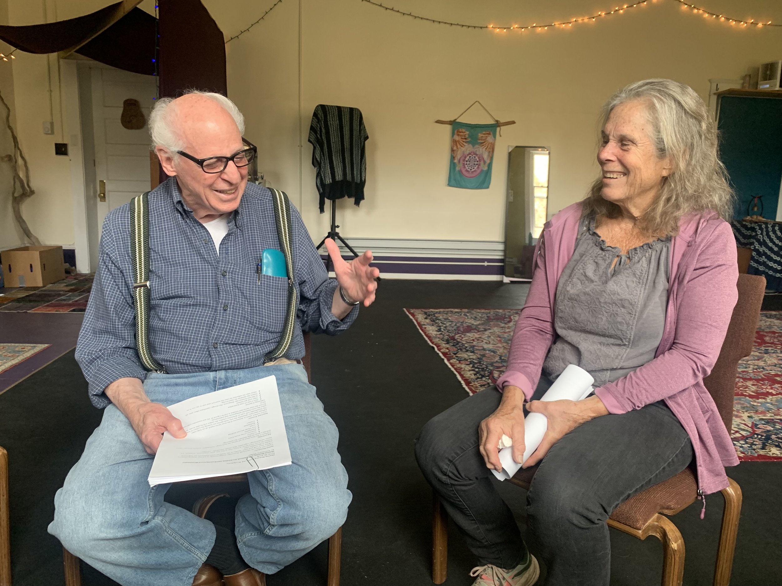 Two older adults smiling in conversation