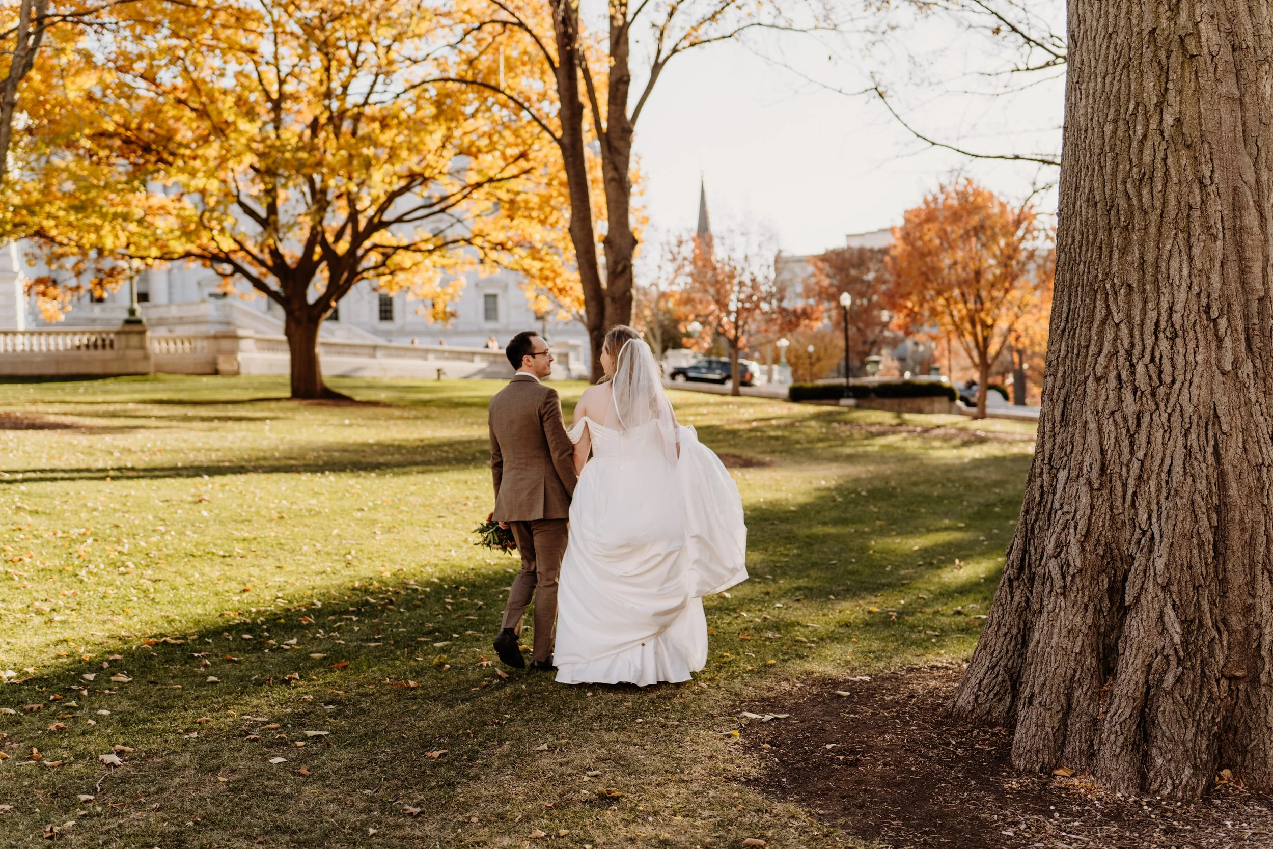 Luxury micro wedding couple walking during golden hour in Wisconsin, highlighting unhurried, intimate wedding moments and serene outdoor scenery