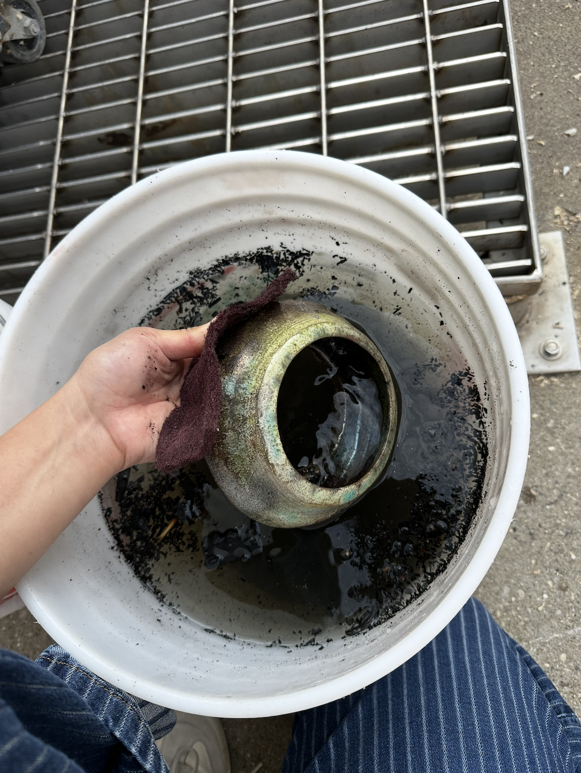 Brushing off combustible materials after raku fire