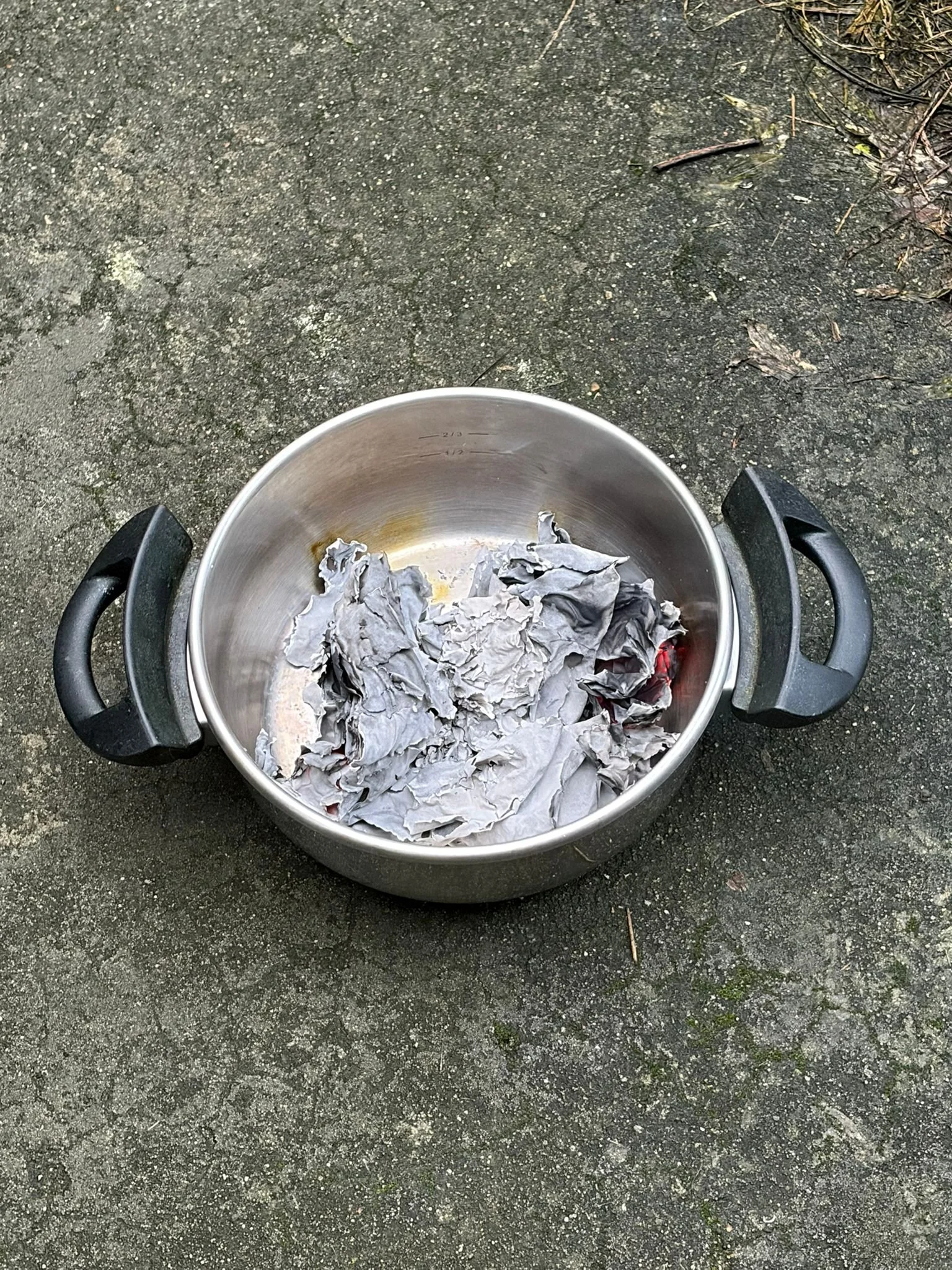 Ashes of paper in a cooking pot