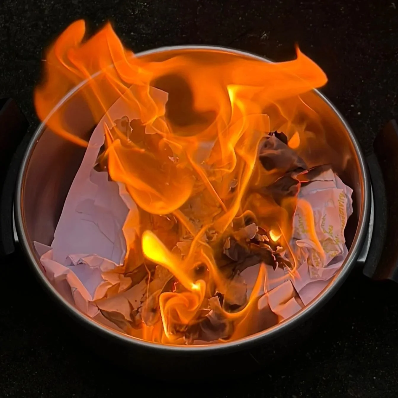 Paper burning in a pot. Big flames.
