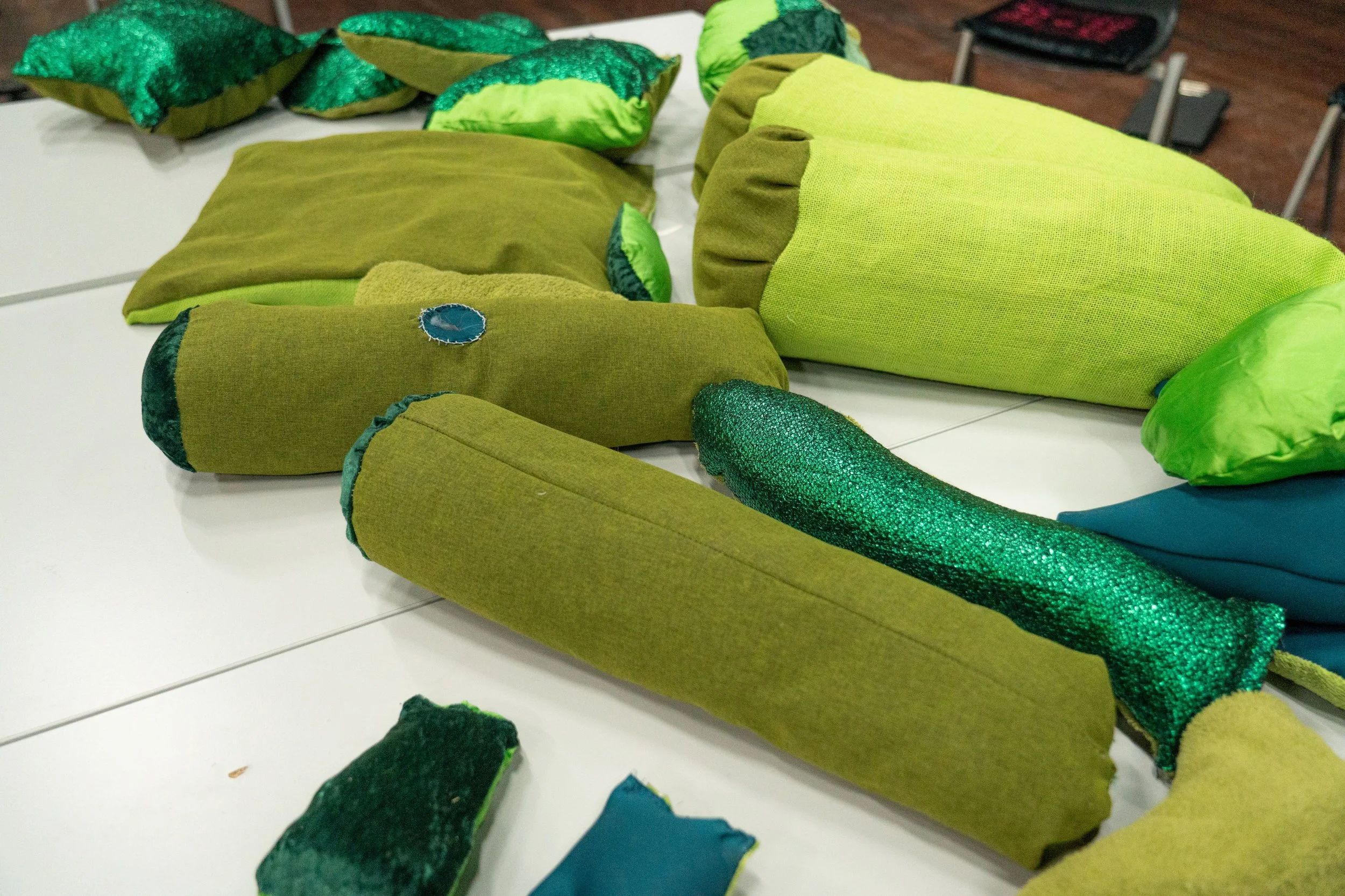 Green fabrics to craft with during a workshop.