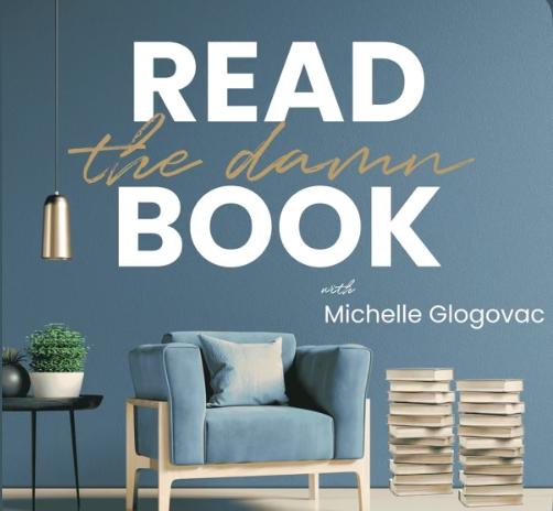 Book cover titled 'READ the damn BOOK' by Michelle Glogovac, featuring a blue armchair, a small side table with a plant, and a stack of books against a blue wall.