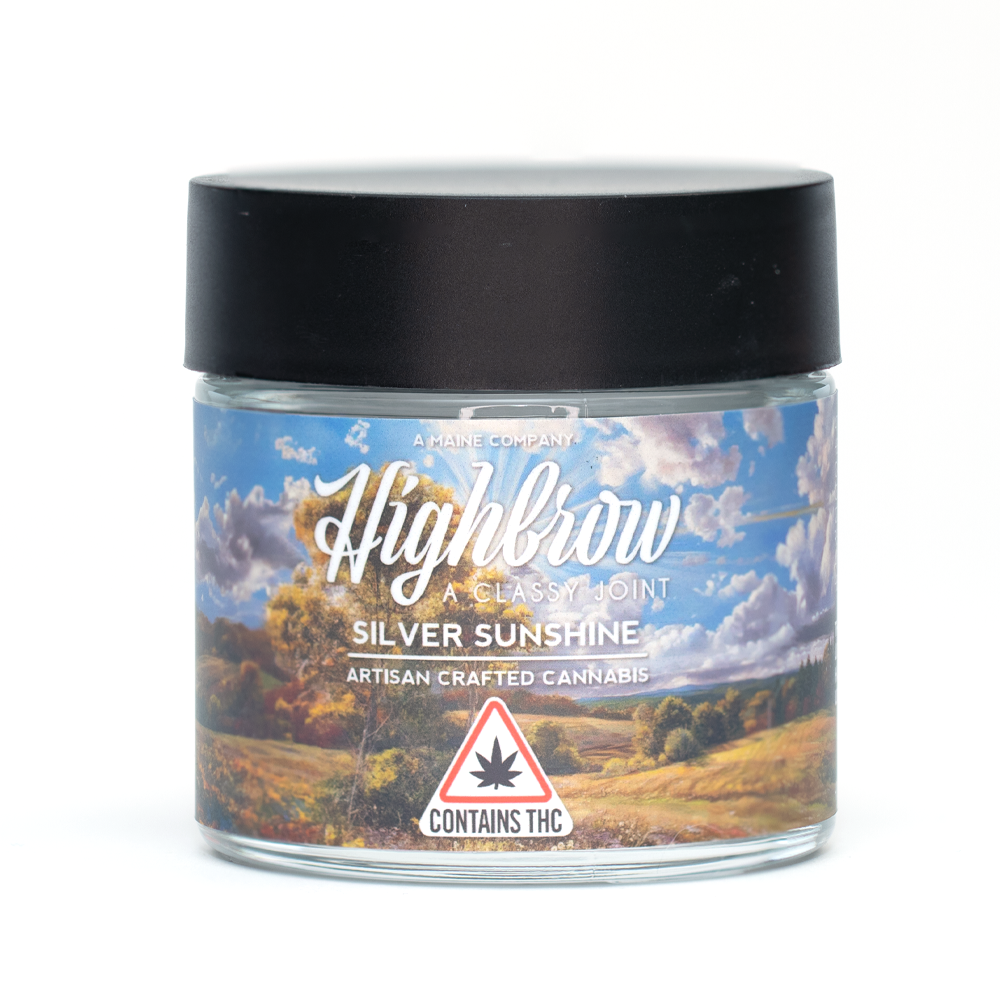 A jar of Highbrow Silver Sunshine artisan crafted cannabis with a scenic landscape label of sky, clouds, trees, and fields, and a warning symbol indicating it contains THC.