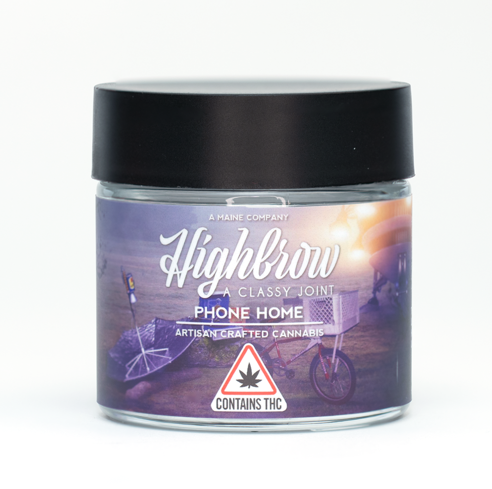 A jar of cannabis product labeled "Highbrow, Phone Home, Artisan Crafted Cannabis" with a sunset scene of beach chairs, an umbrella, and a bicycle on the label, and a warning sign indicating it contains THC.