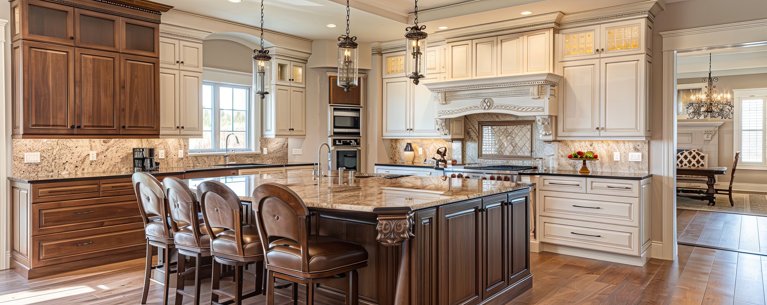 A spacious, luxurious kitchen with a central island, wooden and cream-colored cabinetry, granite countertops, and modern appliances. Pendant lights hang over the island, and a view into a dining area is visible through an open doorway.