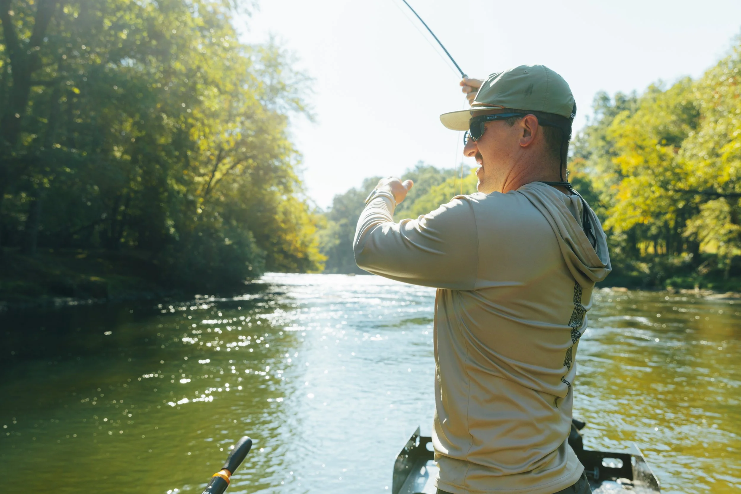 Angler catching a trout on the Toccoa River on a guided fly fishing trip