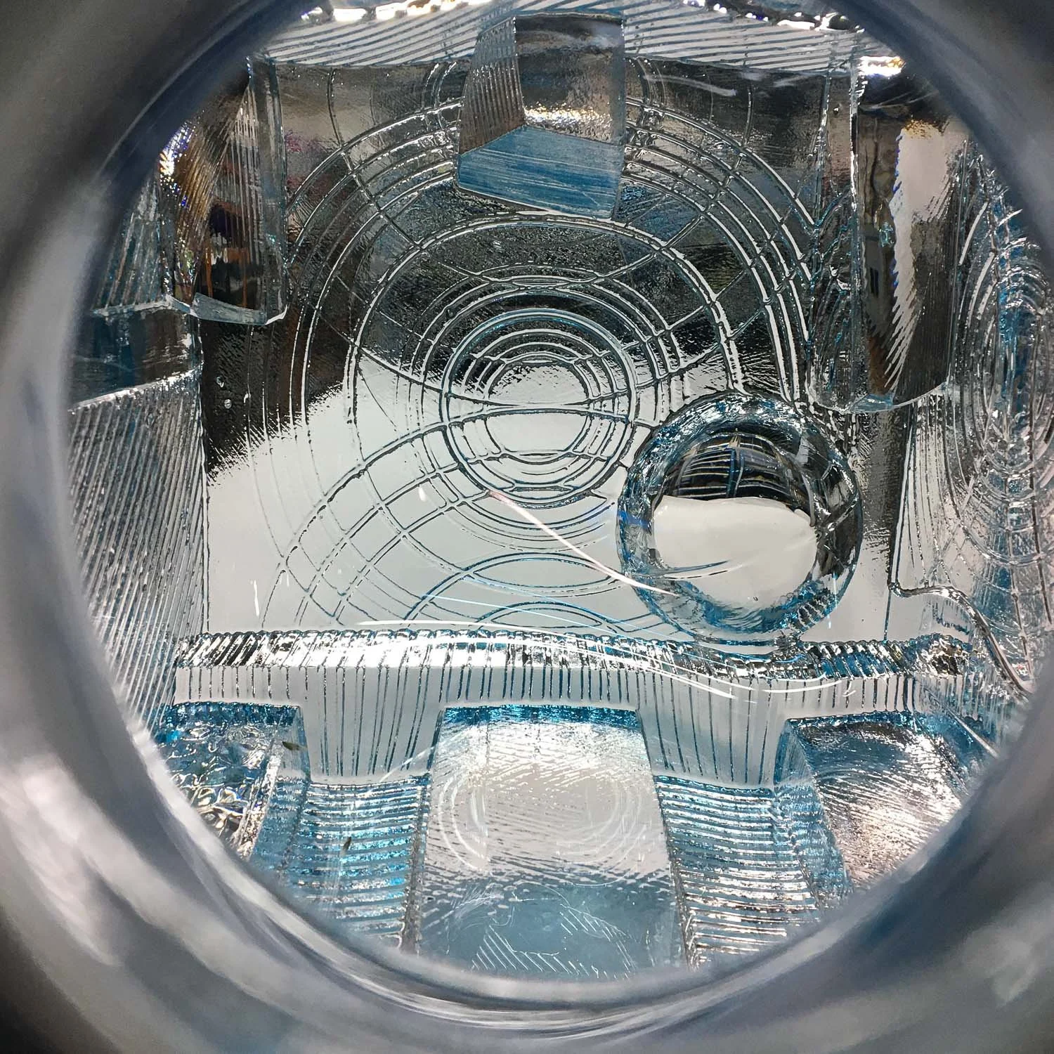 Detail photo of architectural impressions molded into an aqua blue blown glass vessel by Michael Mikula of Cleveland, OH.