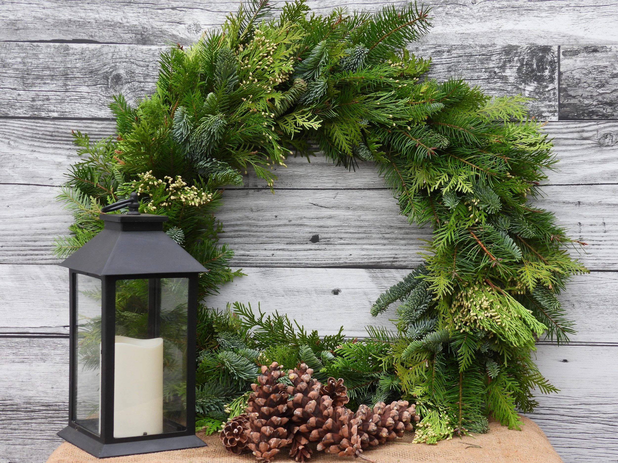 Wreath with lantern and pinecones.JPG