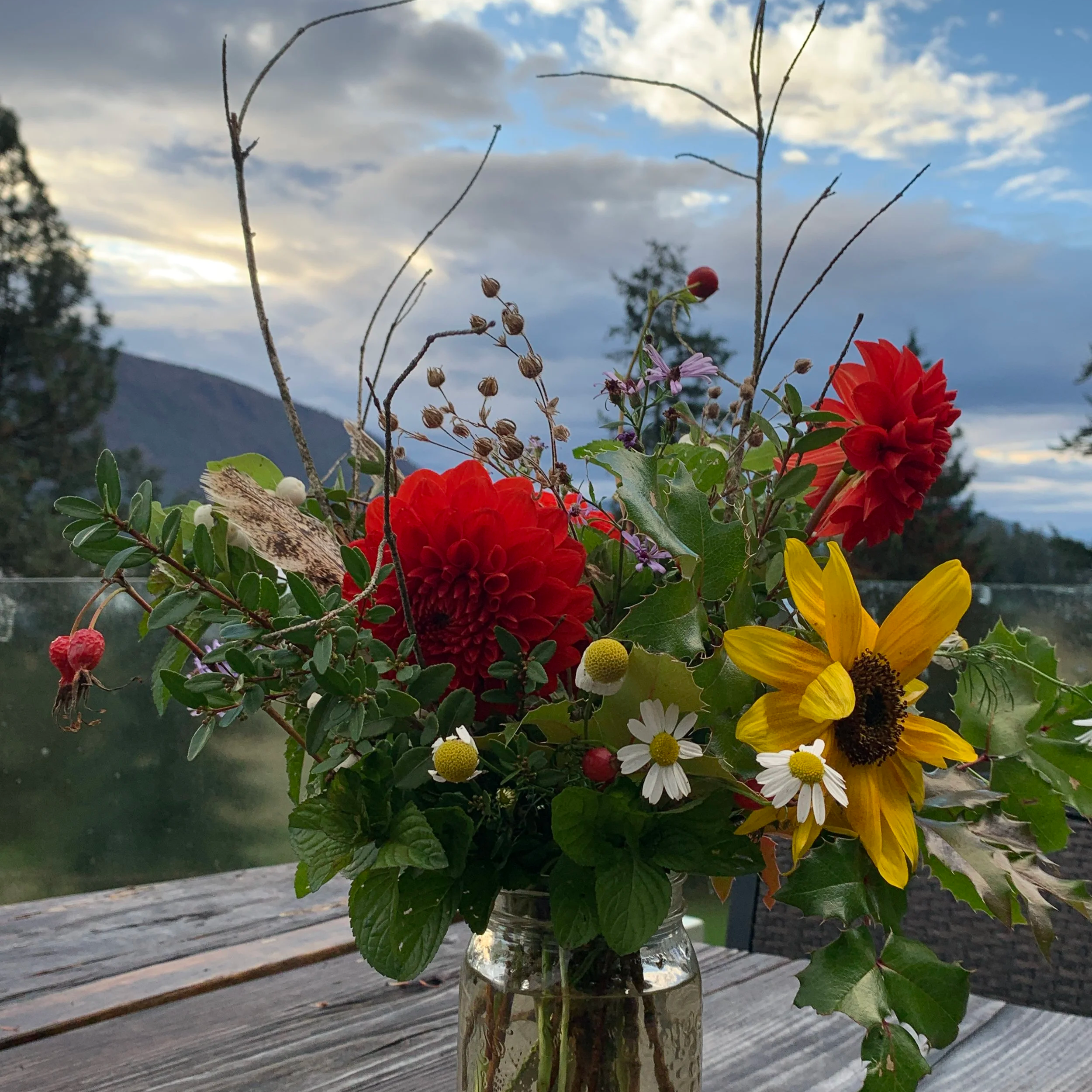 Summer arrangement with red dahlias and sunflowers