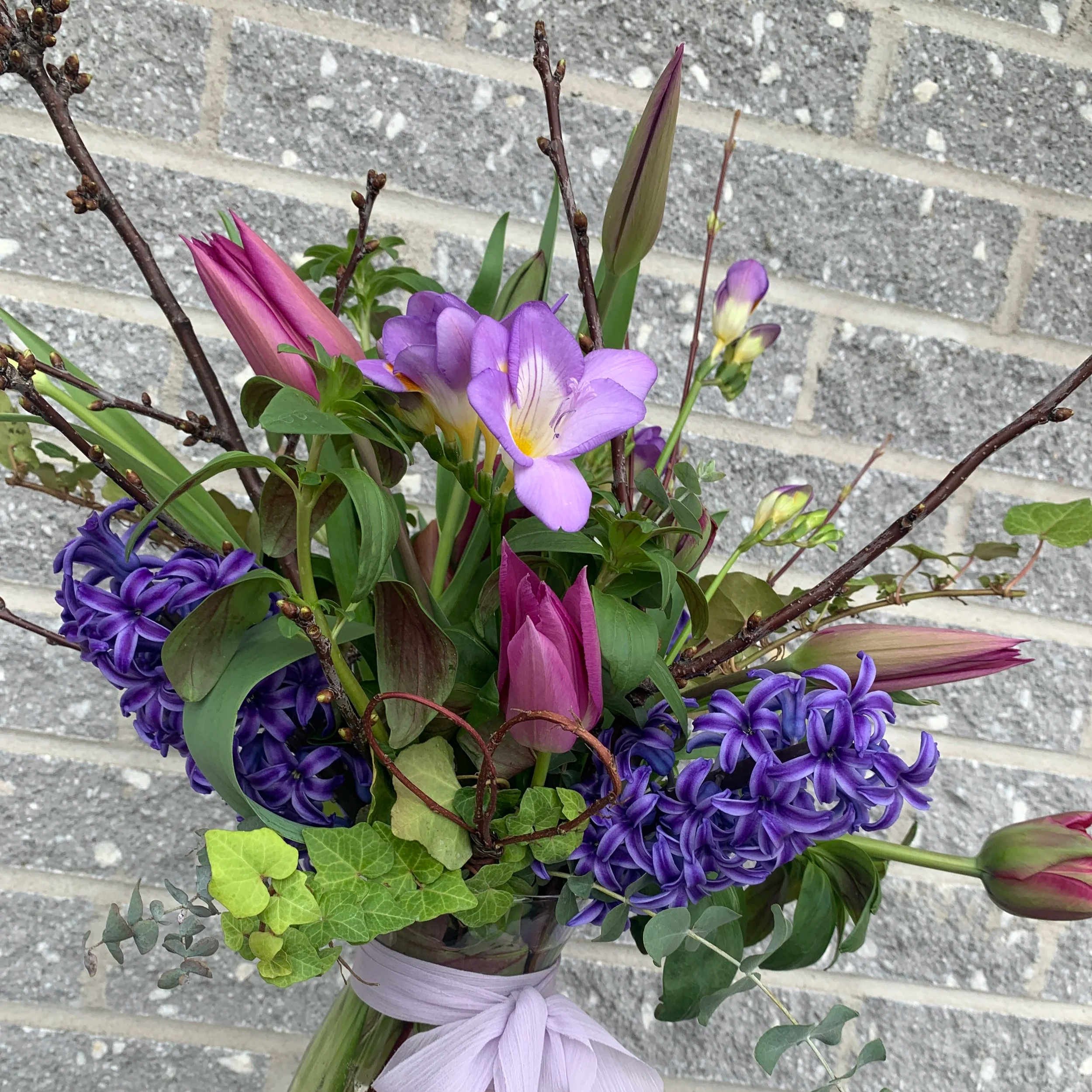 small happy spring flower arrangement in purples