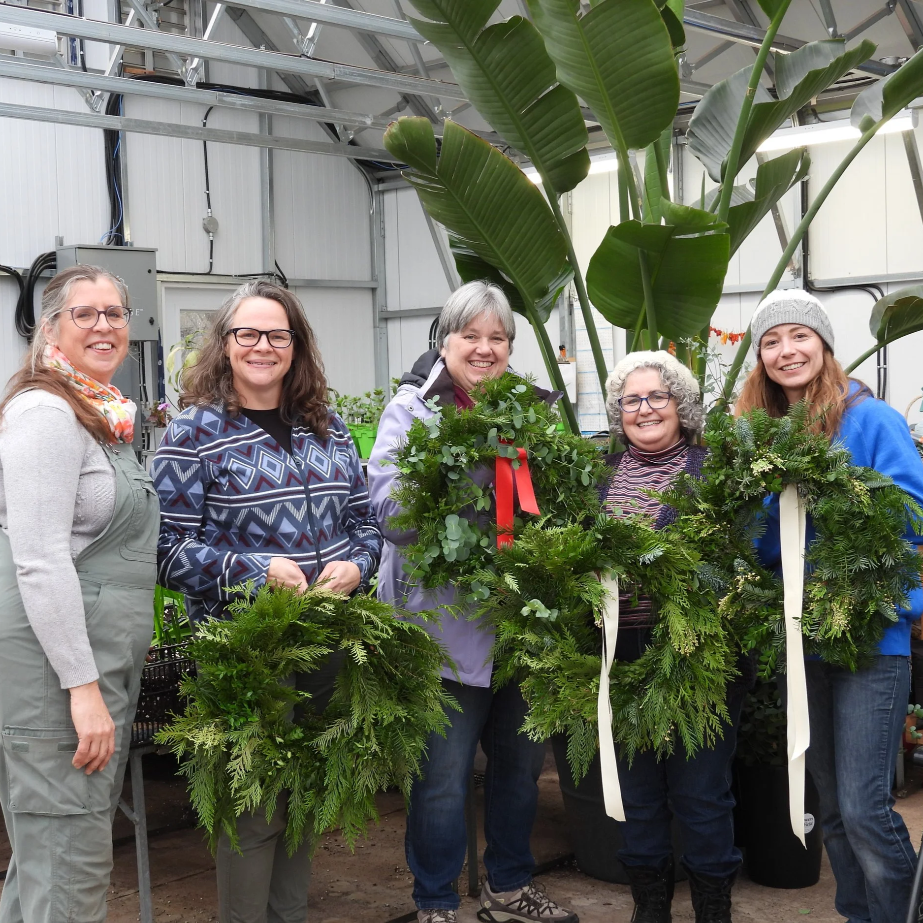 some workshop participants with completed Christmas evergreen wreaths