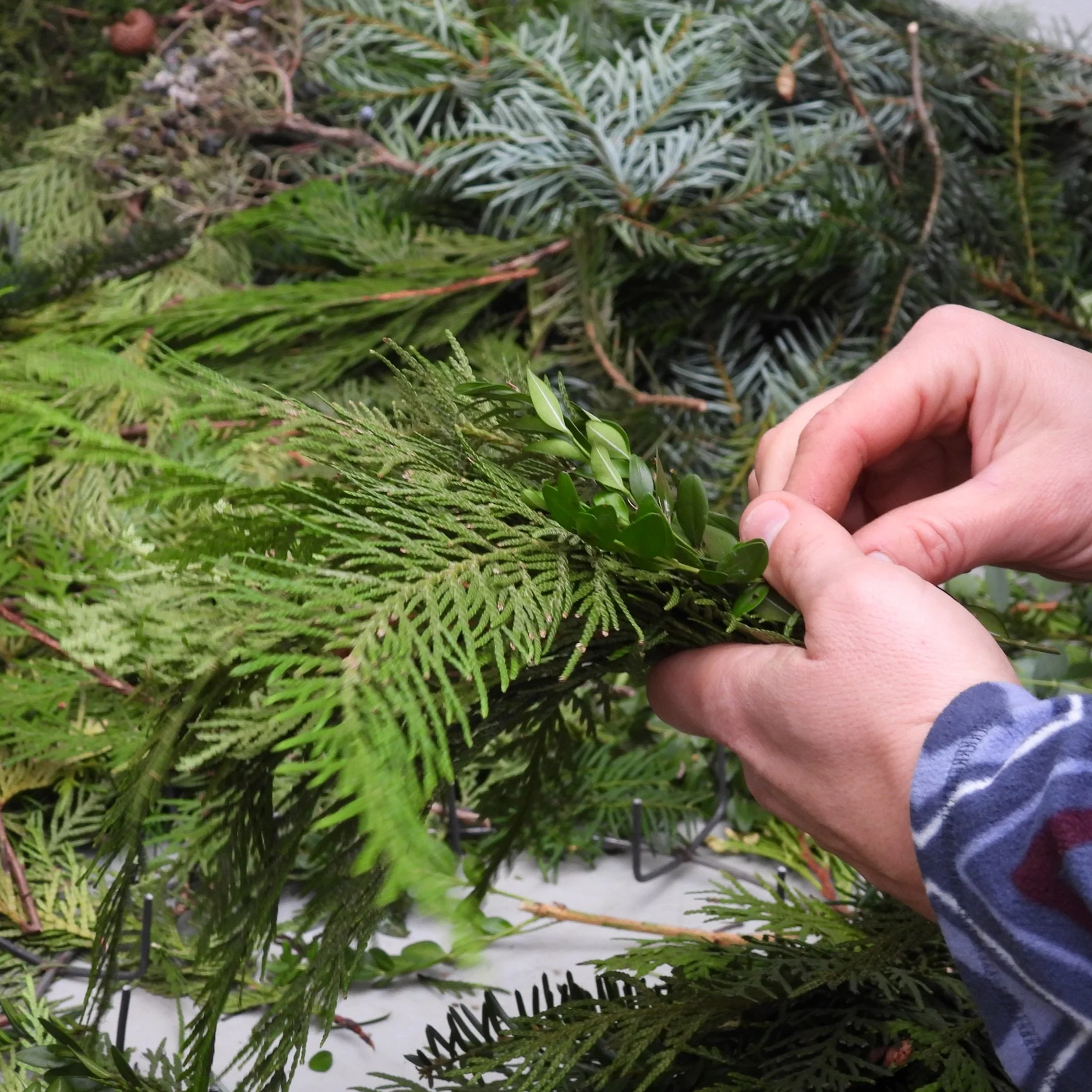 hands making wreath