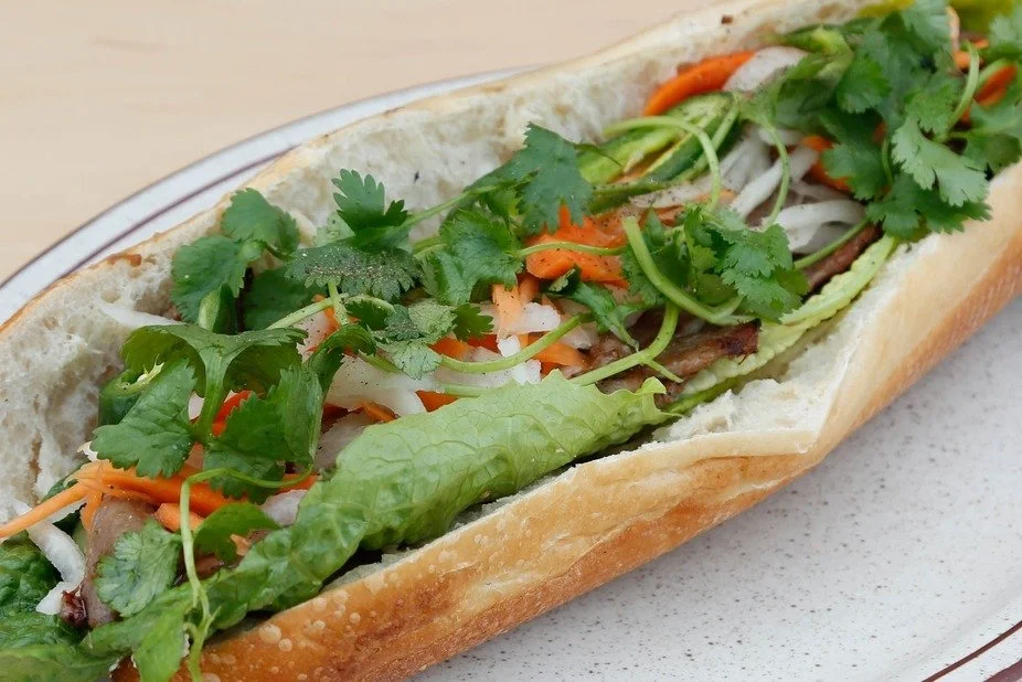 Feast your eyes on the Banh Mi Special! 🥖👀 A symphony of pork roll, ham, and pate nestled in a crusty baguette. Who can resist this Vietnamese delight? 😋🌿 Dive into the perfect blend of savory meats and fresh herbs. Ready for a flavor journey? 🚀