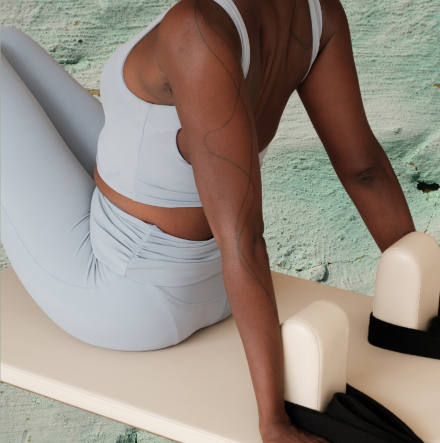 Woman performing reformer pilates at Studio East reformer pilates studio in Wanstead, East London