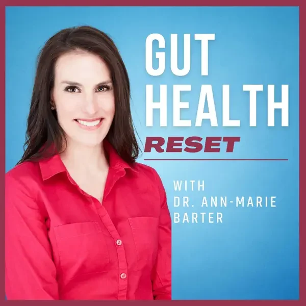Book cover titled "Gut Health Reset" by Dr. Ann-Marie Barter, featuring a woman with dark hair in a red shirt smiling against a blue background.