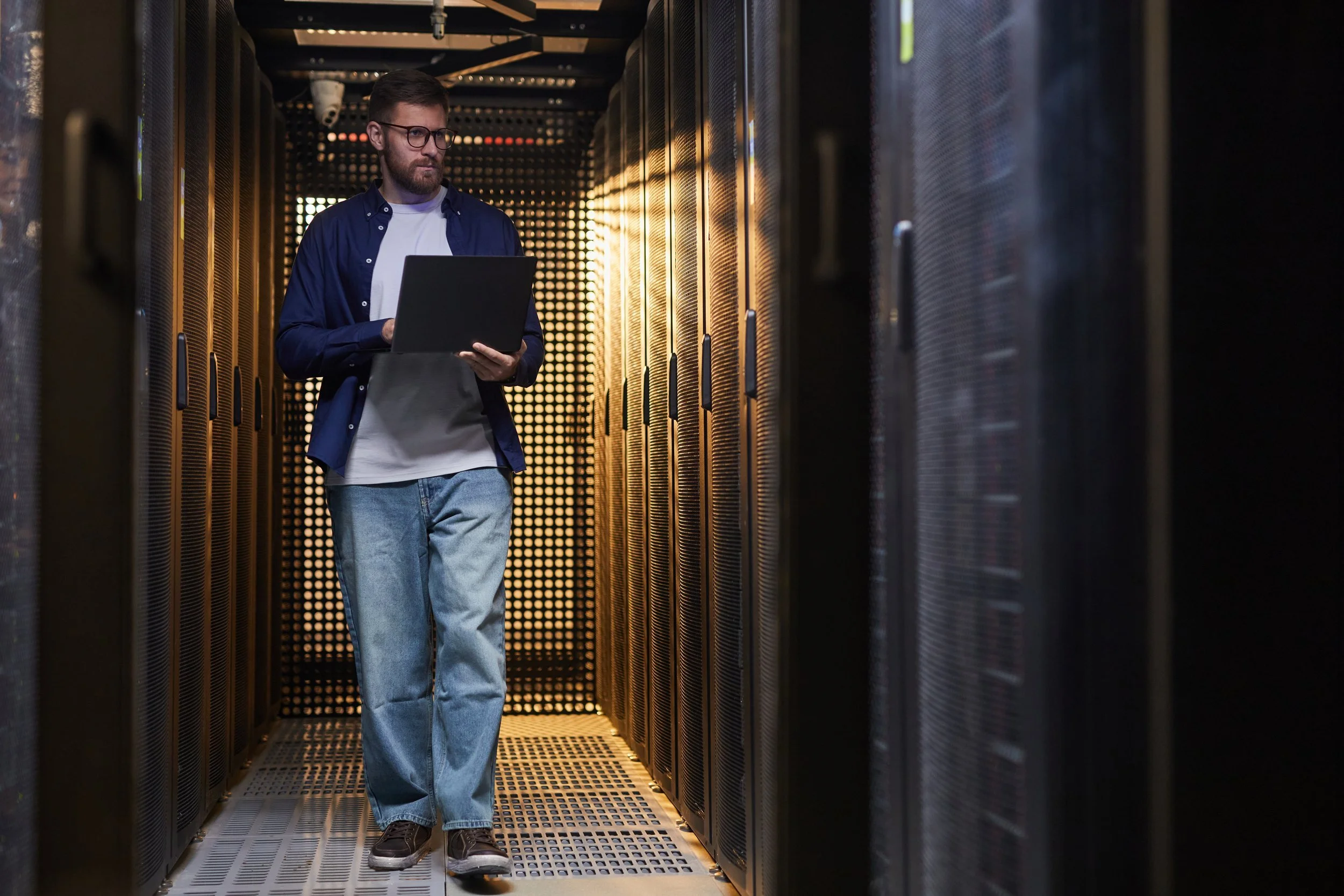 data center operations engineer in a rack and stack aisle