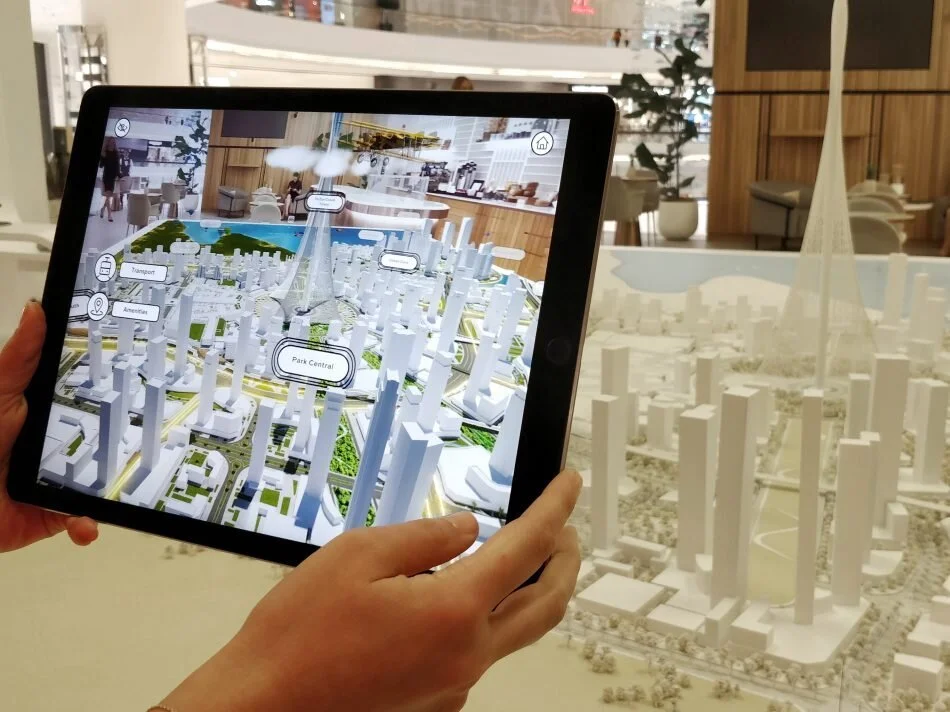 A visitor using the iPad app at the model table