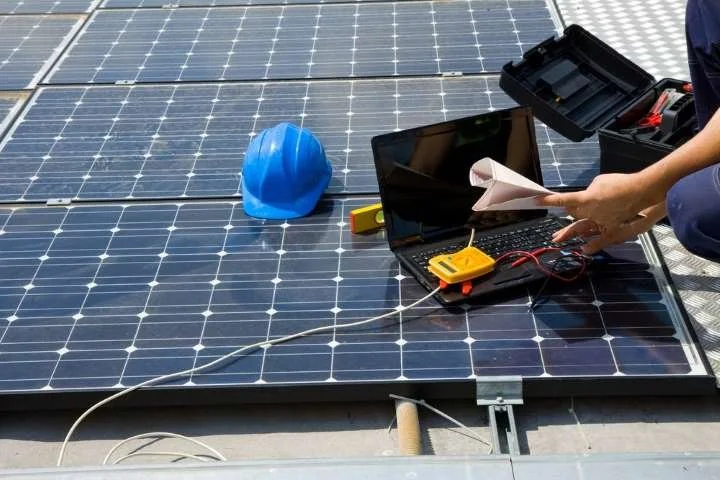Solar panel repair technician servicing rooftop system in Hollister CA
