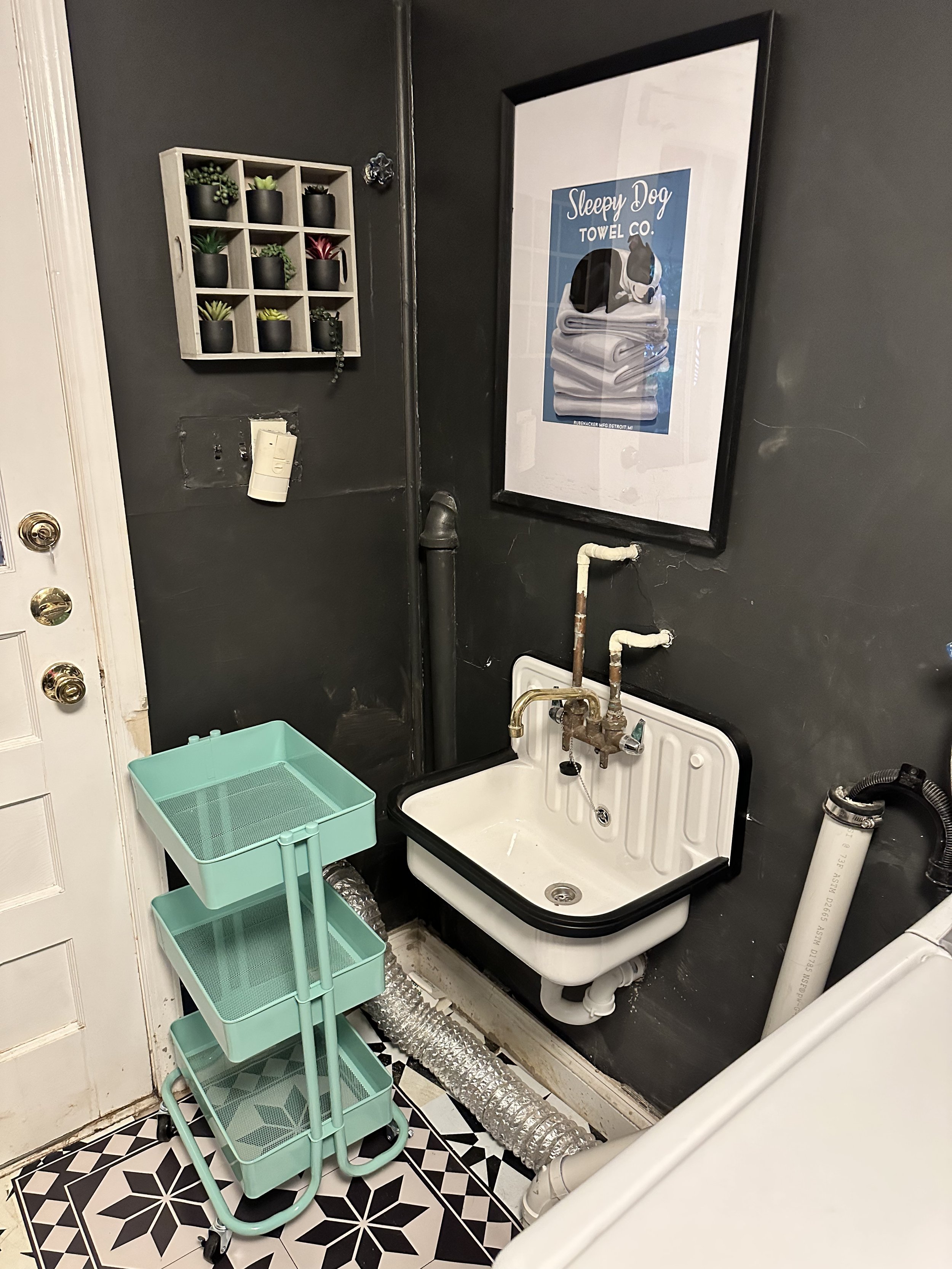 The plumbers left a patch of bare concrete here that the vinyl tiles won't stick to, so for now I've got it covered with a matchy vinyl rug about the size of a bathmat. Again, it's the laundry room, I'm not as precious about that. 
