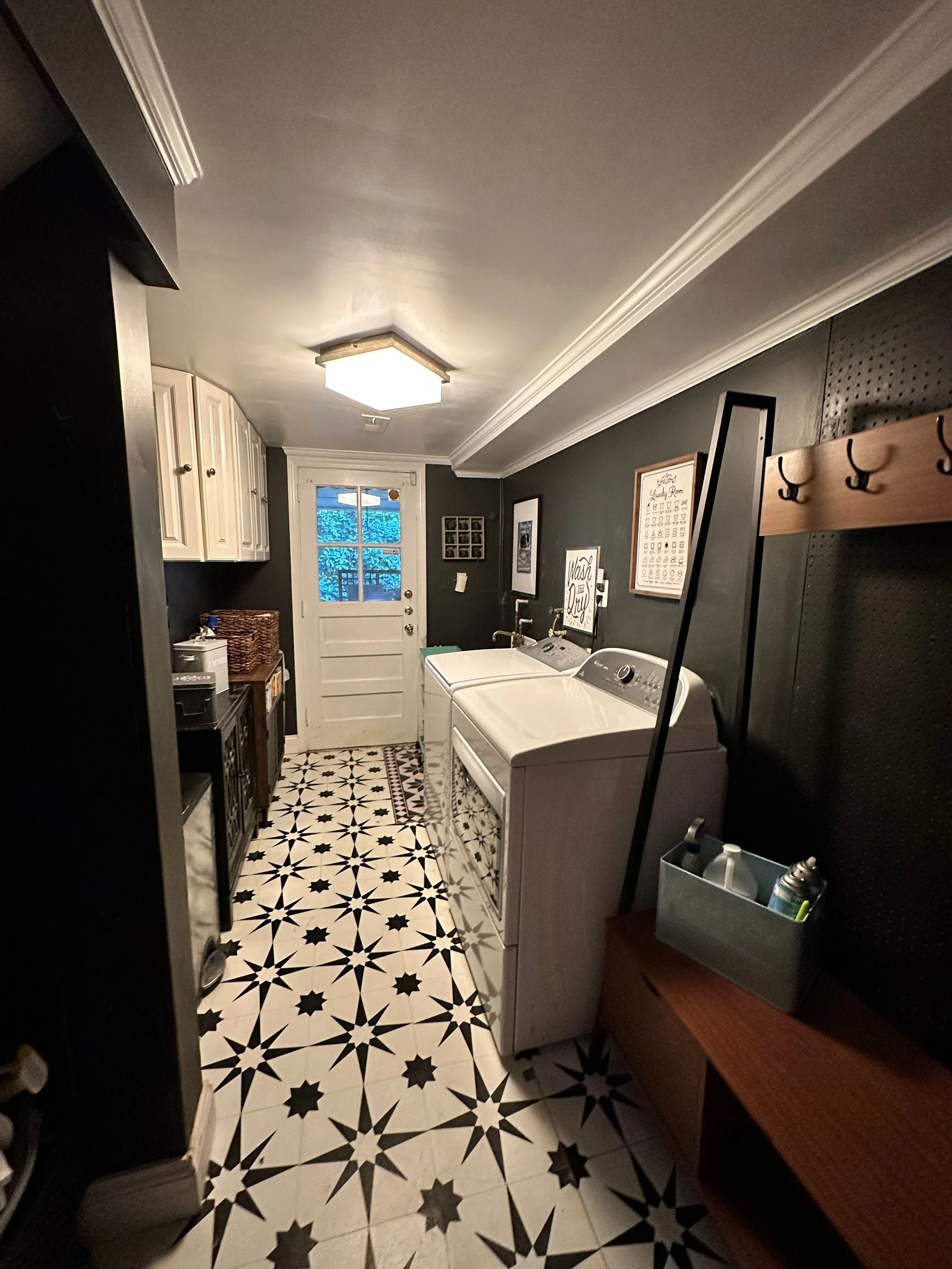 AFTER: These vinyl tiles make such a huge difference! I kept the suspended upper cabinets because I needed the storage for paint. The hall tree at the entrance functions as a quick place to hang up items to dry, including towels that have just come h