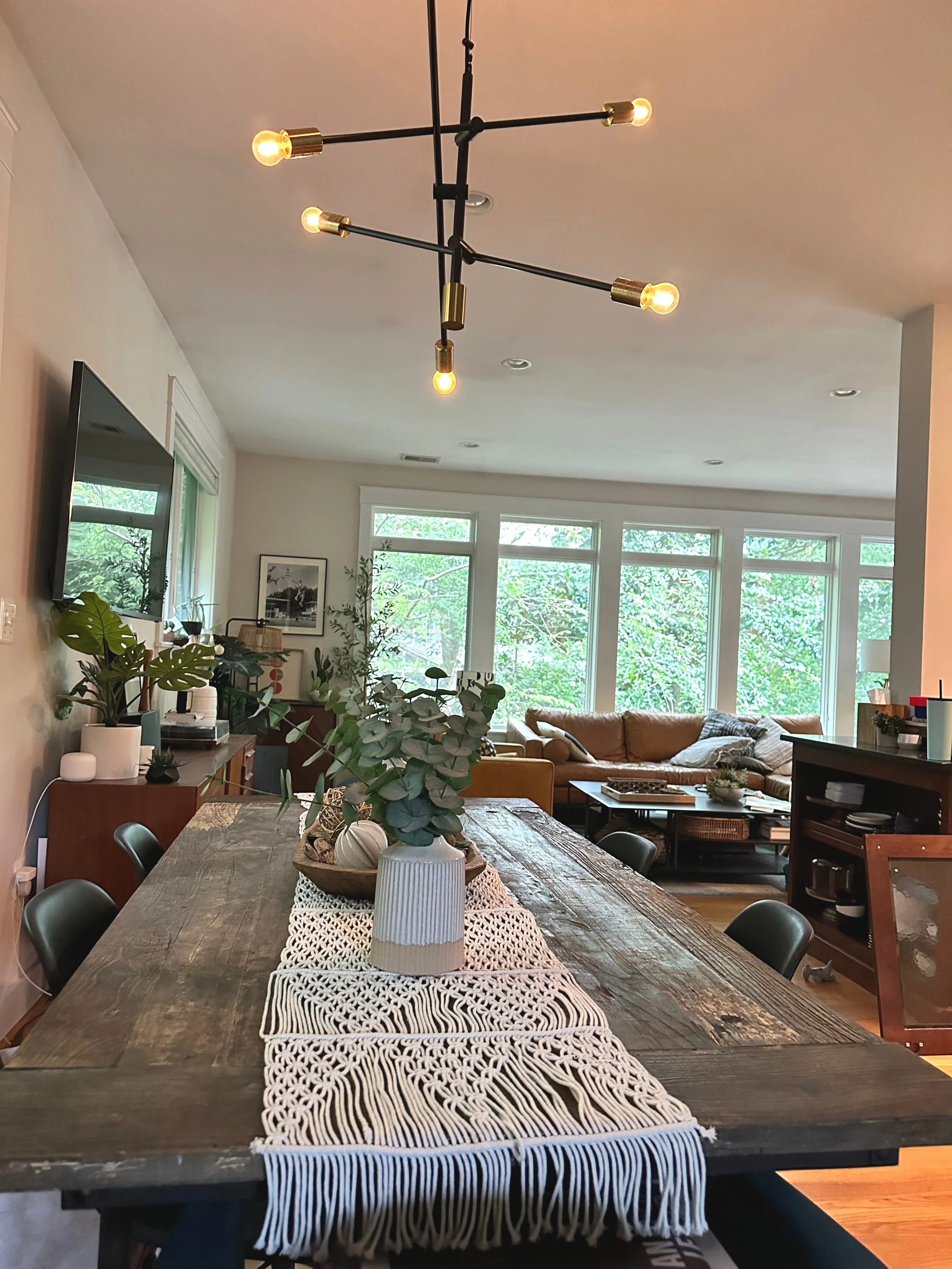 This dining room table is an old reclaimed barn door - there's something sassy and delightfully unexpected about pairing that rustic vibe with the molded-plastic midcentury chairs