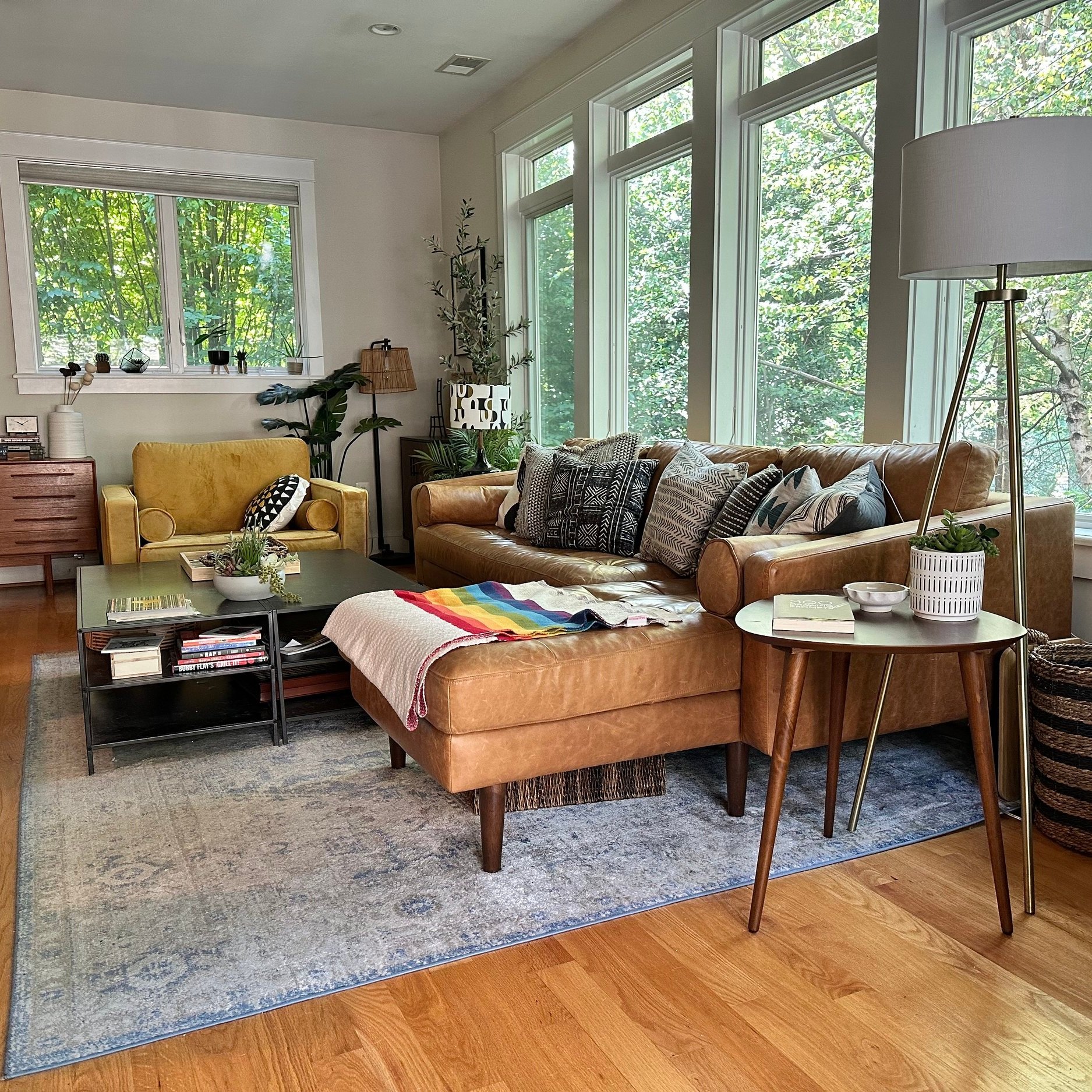 AFTER: Did you even notice all the trees in the BEFORE picture? The green really pops in this room when you contrast it with the rich caramel of the Poly+Bark leather sofa
