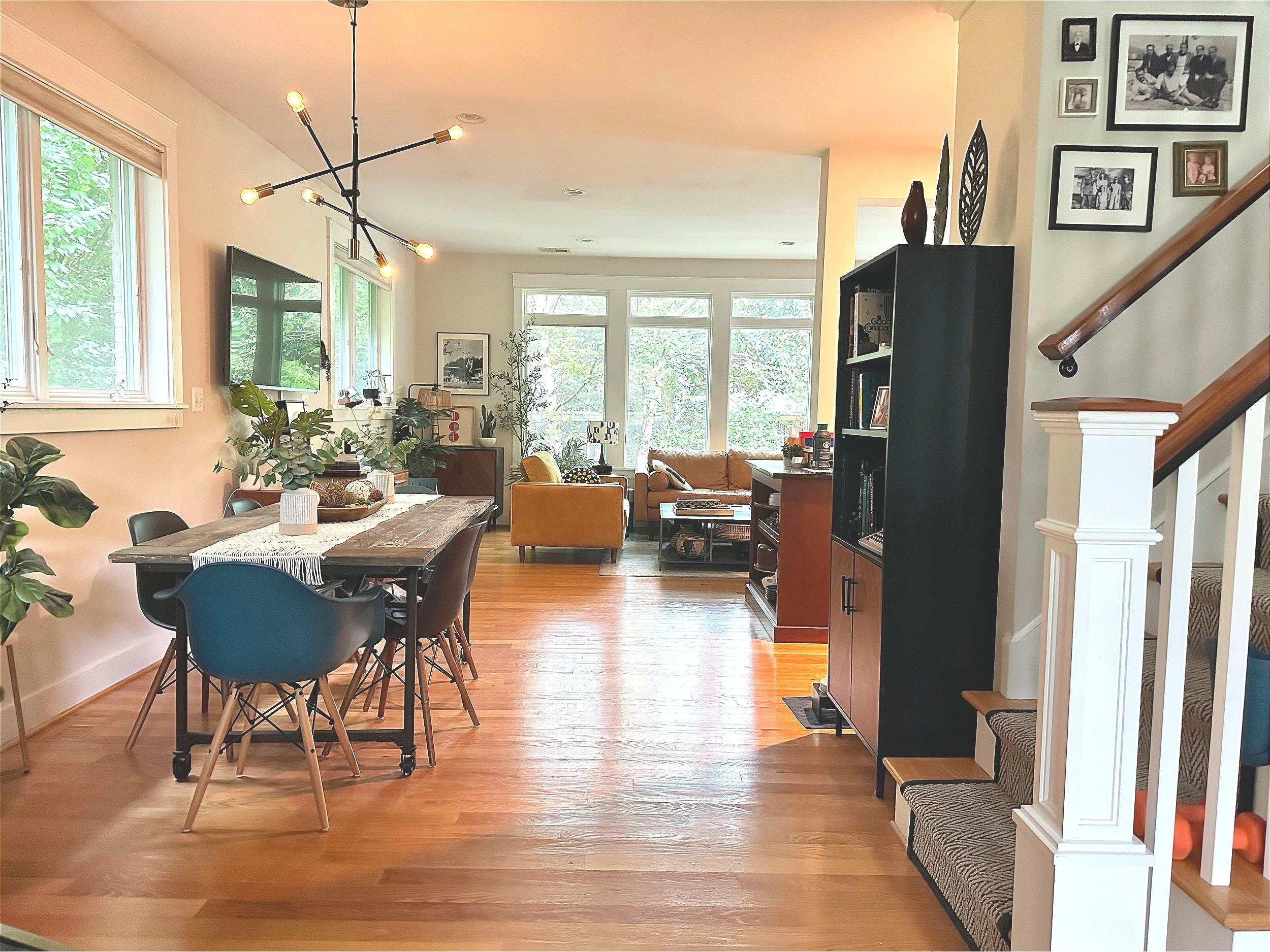 AFTER: new light fixture, knockoff molded-plastic Eames chairs, and a dining table made of a reclaimed barn door