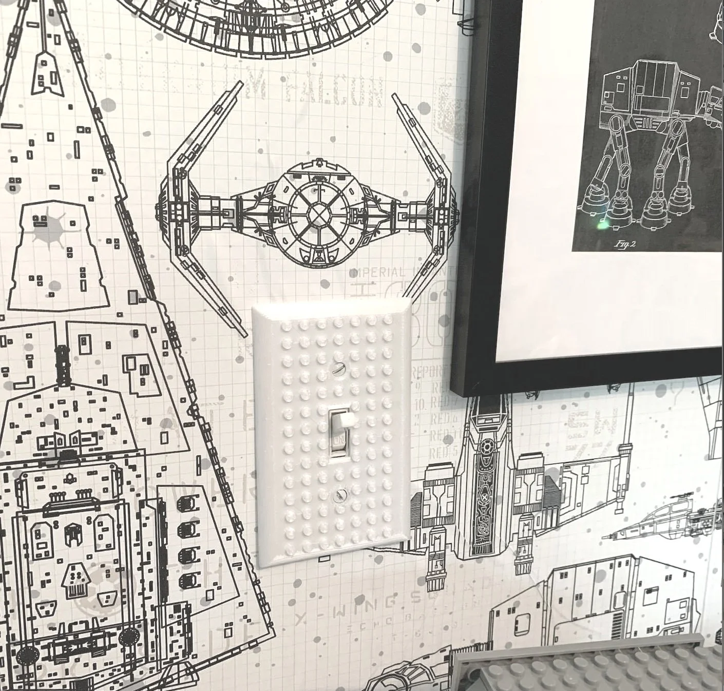 detail of the wallpaper and a cool LEGO switchplate (3D printed, from Etsy) that you can actually attach little LEGOs to. 
