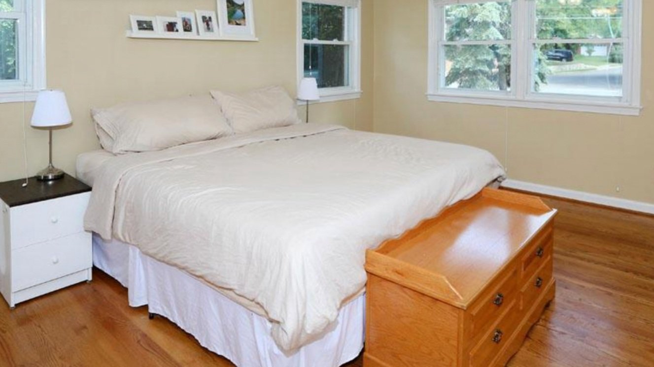 BEFORE: a terribly depressing, yellow-tan bedroom. Why do people paint their entire interiors this color? 