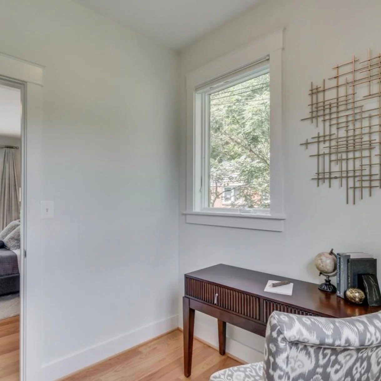 BEFORE: This half of the walk-in closet was staged as an office area, which during the pandemic was a big selling point! It didn't make sense, though, to have the view of anyone you're zooming with to be the entirety of your closet and clothing