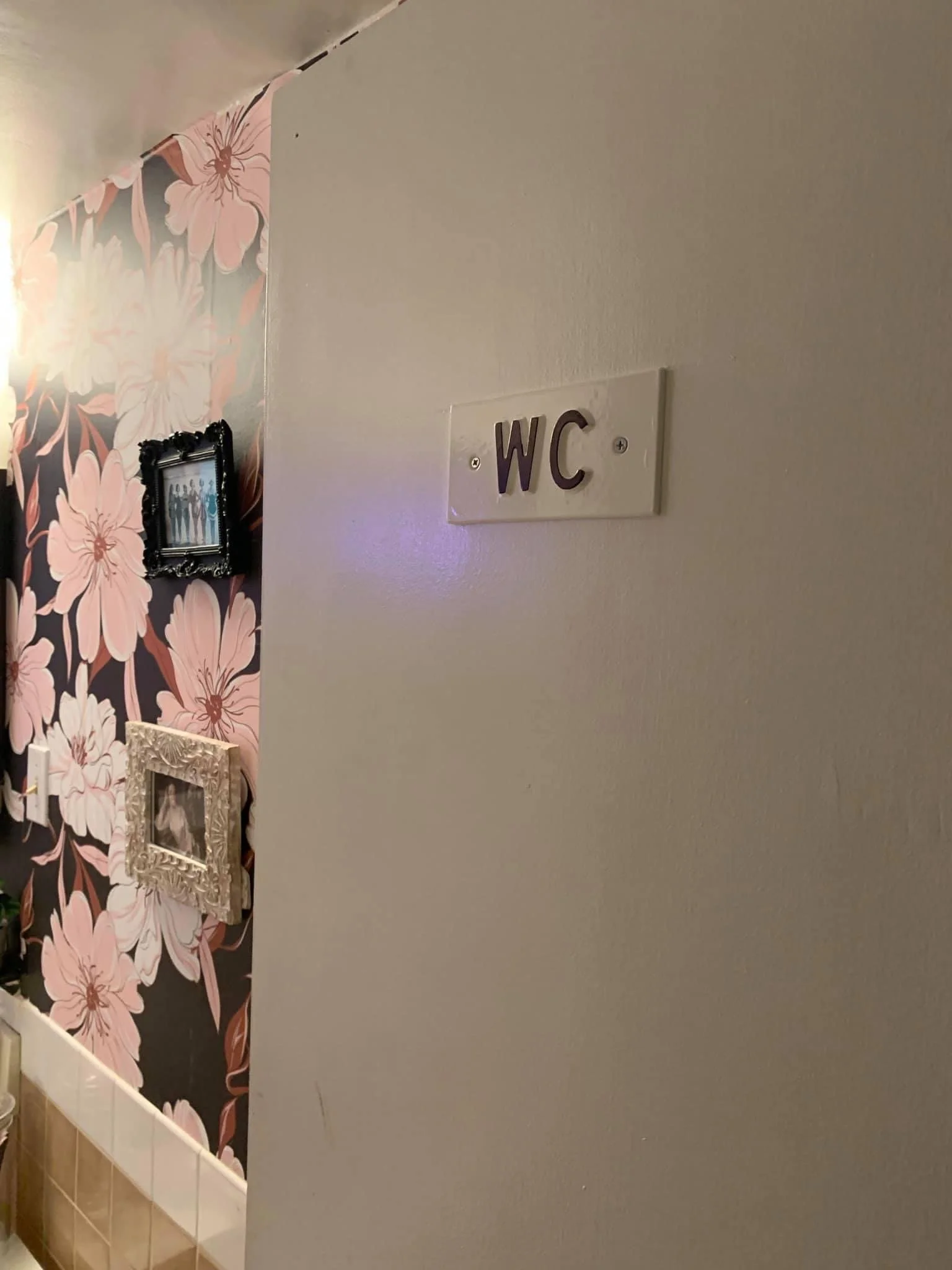 An old-school, cast iron "water closet" sign on the door alerts guests that this isn't a normal powder room. 