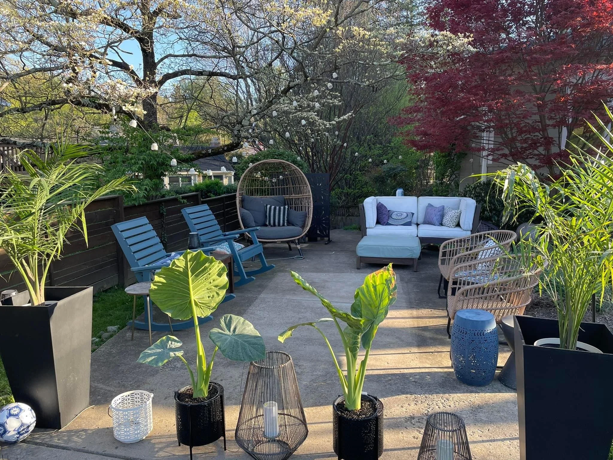 AFTER: I used patio furniture to define a space, about 2/3 of the driveway that we use for our patio. The outdoor rug is missing from this picture as I was about to powerwash. 
