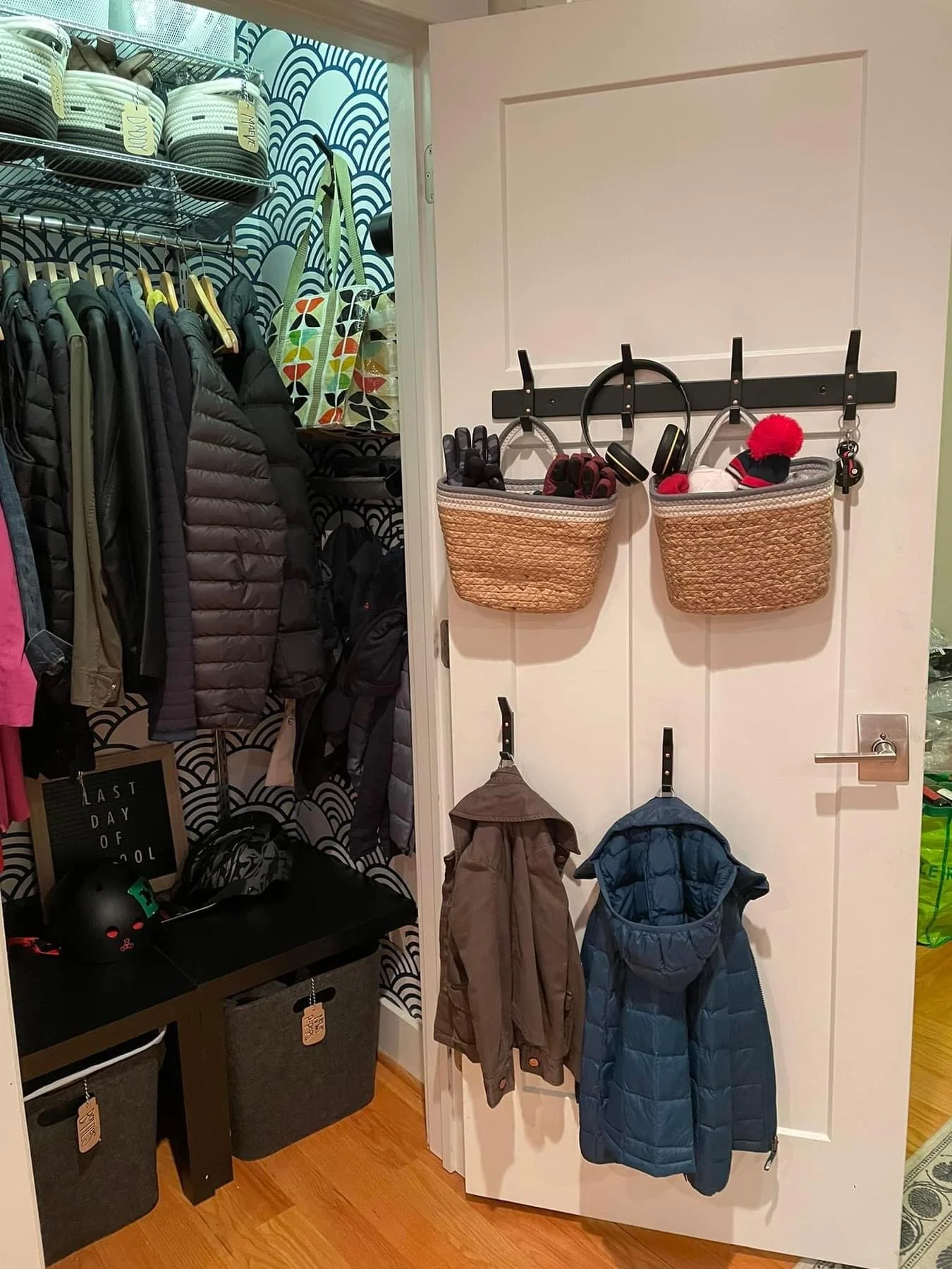 a rack on the door holds little flattened baskets for the kids' winter hats, and low hooks hold just the youngest child's jackets so he can get dressed without assistance to reach anything 