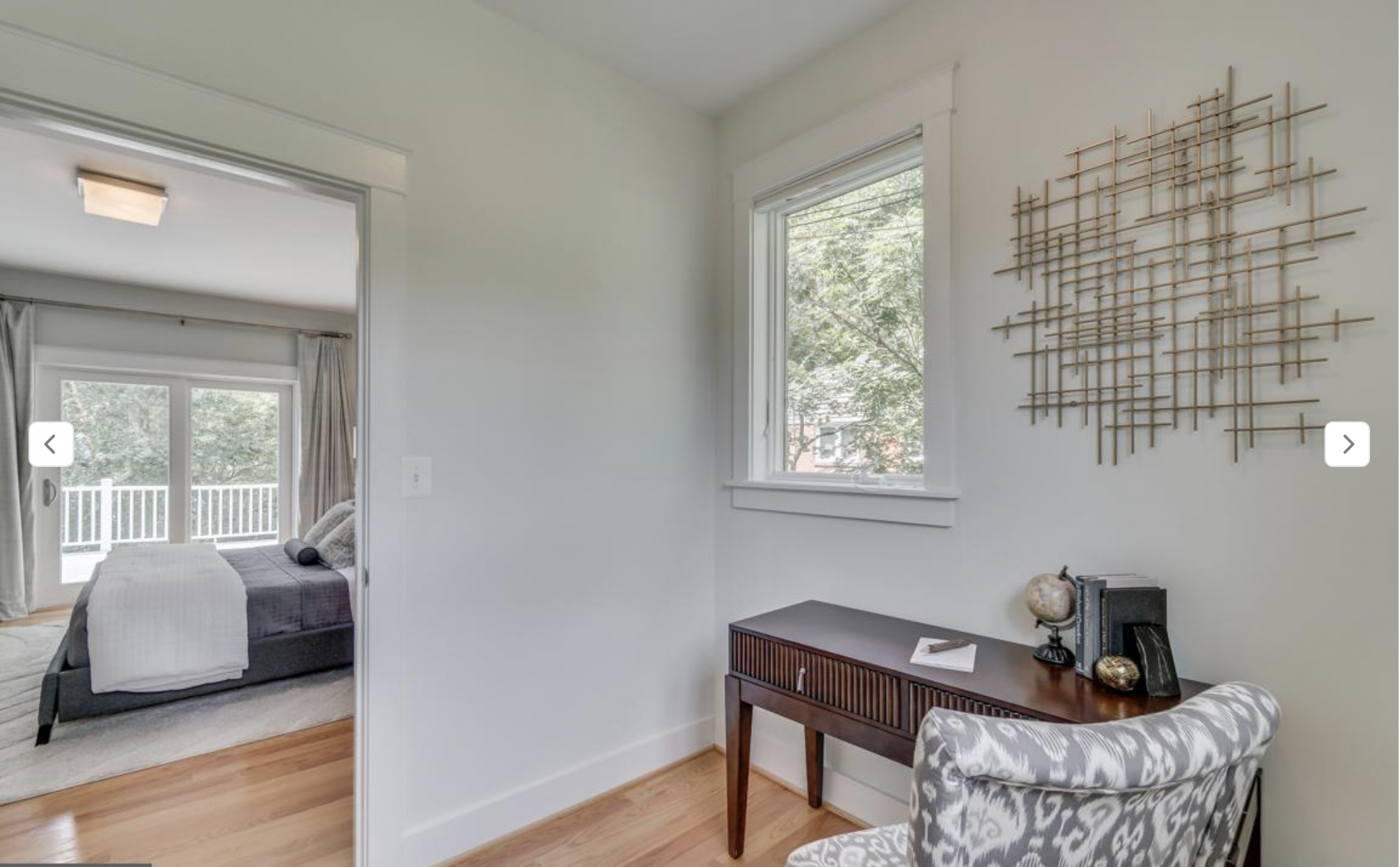 BEFORE: The primary bedroom's walk-in closet, half of which is staged as a work from home area with very bad feng shui (back to the door!)