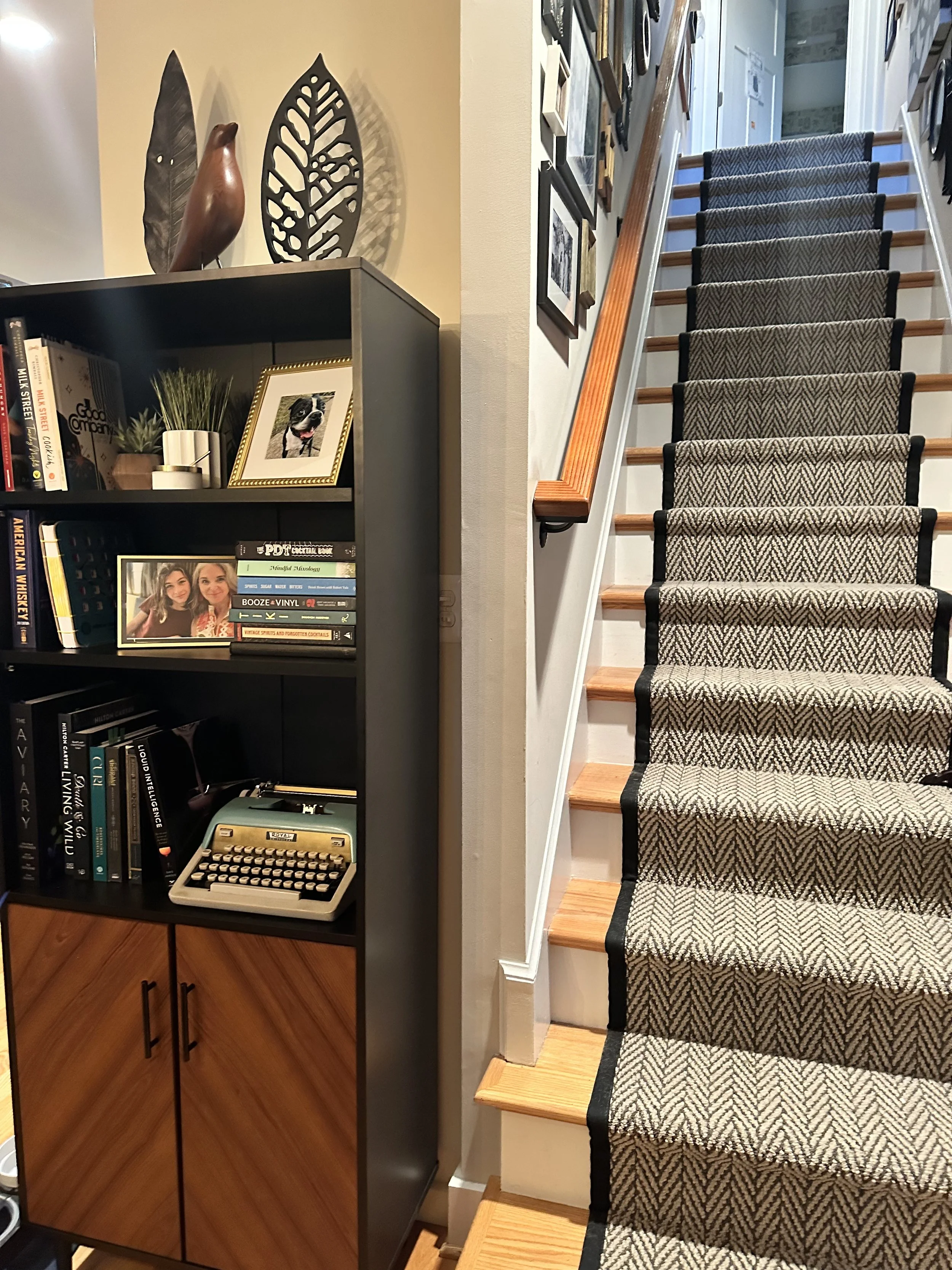 This MCM hutch stores recycling bins behind the doors at the bottom, and on top provides a place to showcase a few favorite photos as well as all of the husband's cocktail books.