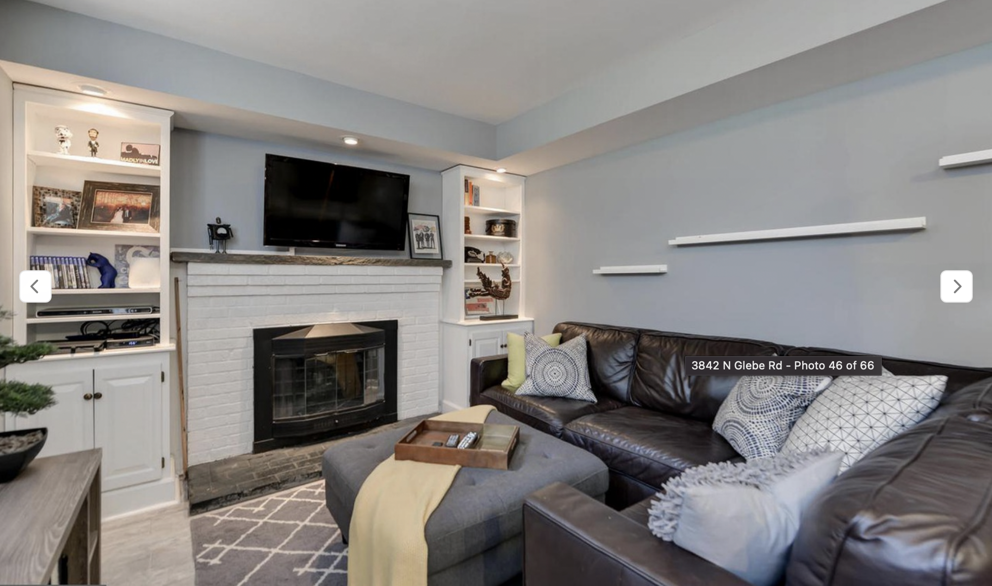 AFTER: Removing the doors from the tops of the shelving units and painting the units white gave this an *almost* built-in look. This became a cozy hangout spot for the kiddos. 