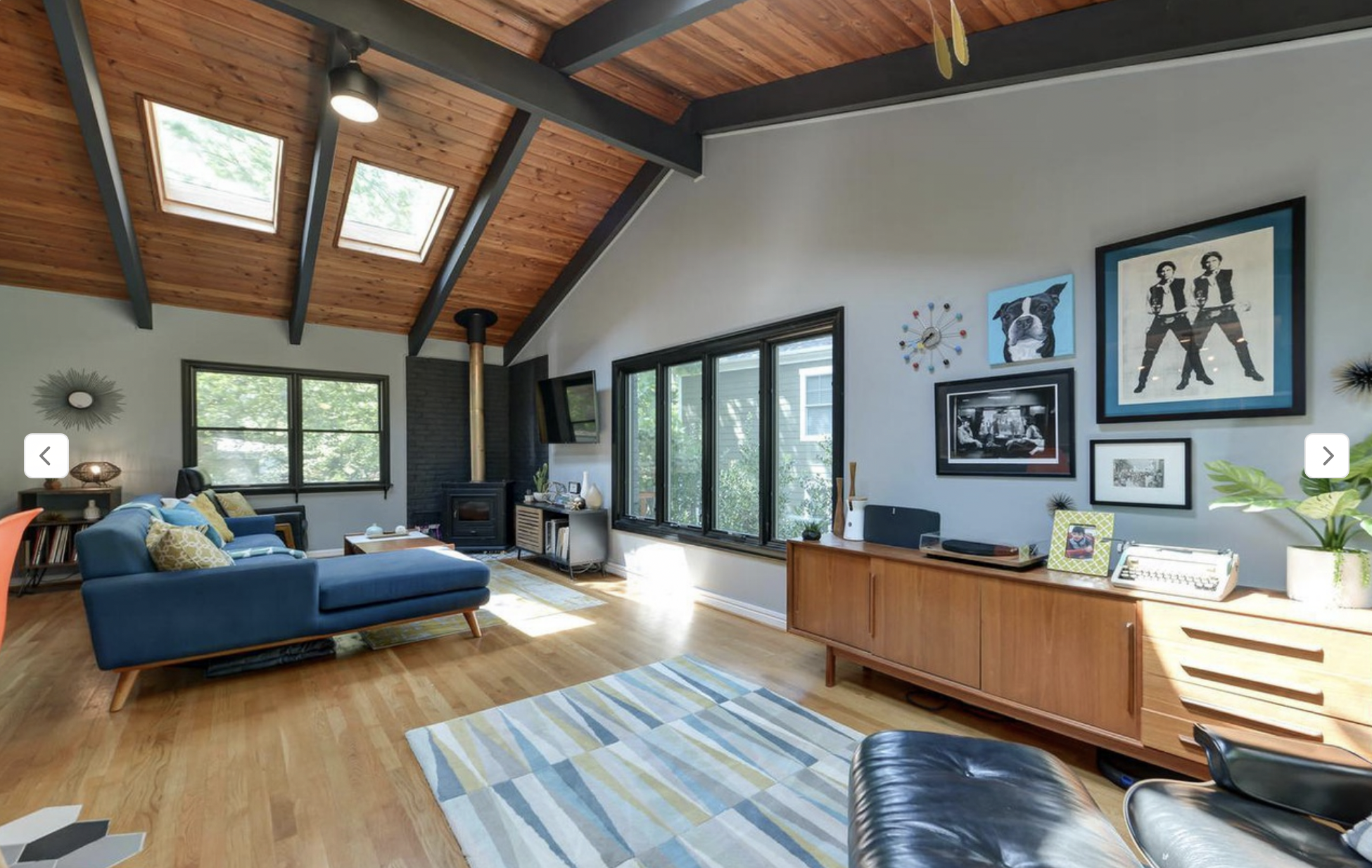 AFTER - it's amazing how much you can change the look of a room with paint, isn't it? The pale gray did a lot to cool down all those oranges and yellows, but the real shift came when we painted the beams in the ceiling in Iron Ore (Sherwin Williams).