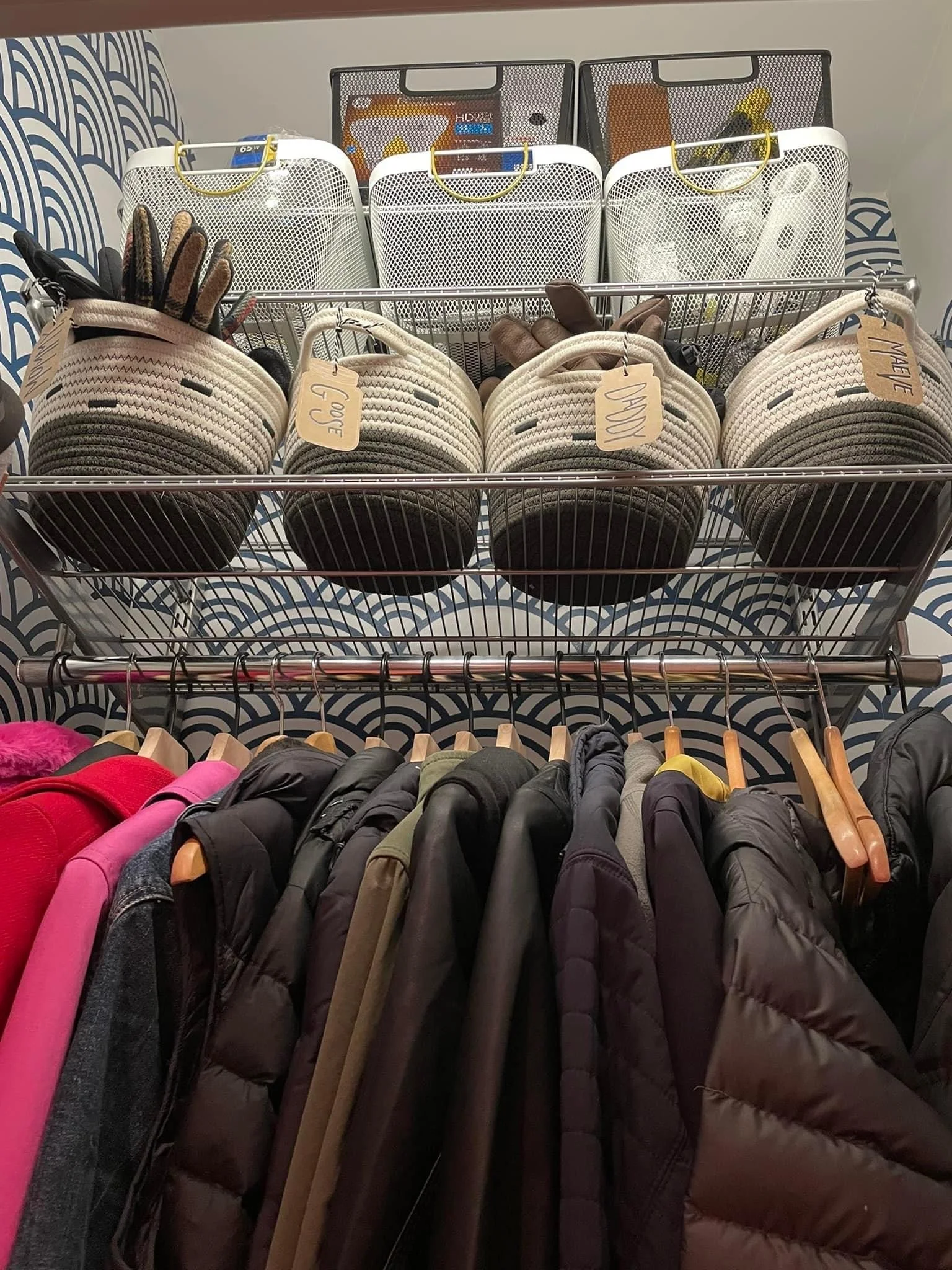 AFTER: Matching white mesh baskets up top hold lightbulbs, and the soft baskets hold gloves for each family member (labeled with little craft paper tags with their names). Just homogenizing all the hangers to match makes a huge difference to the eye.