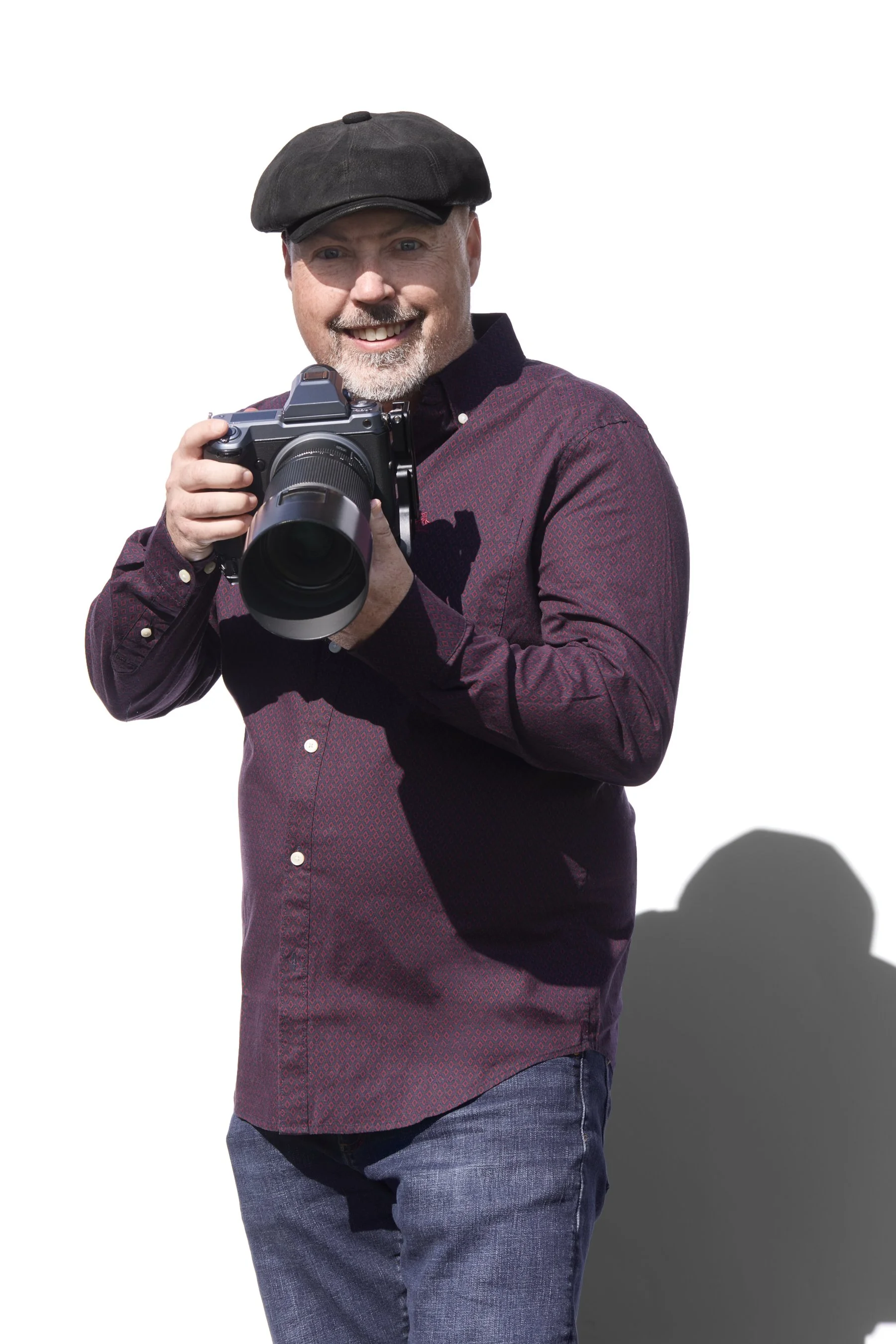 Steven Paul, architectural photographer, holding a camera.