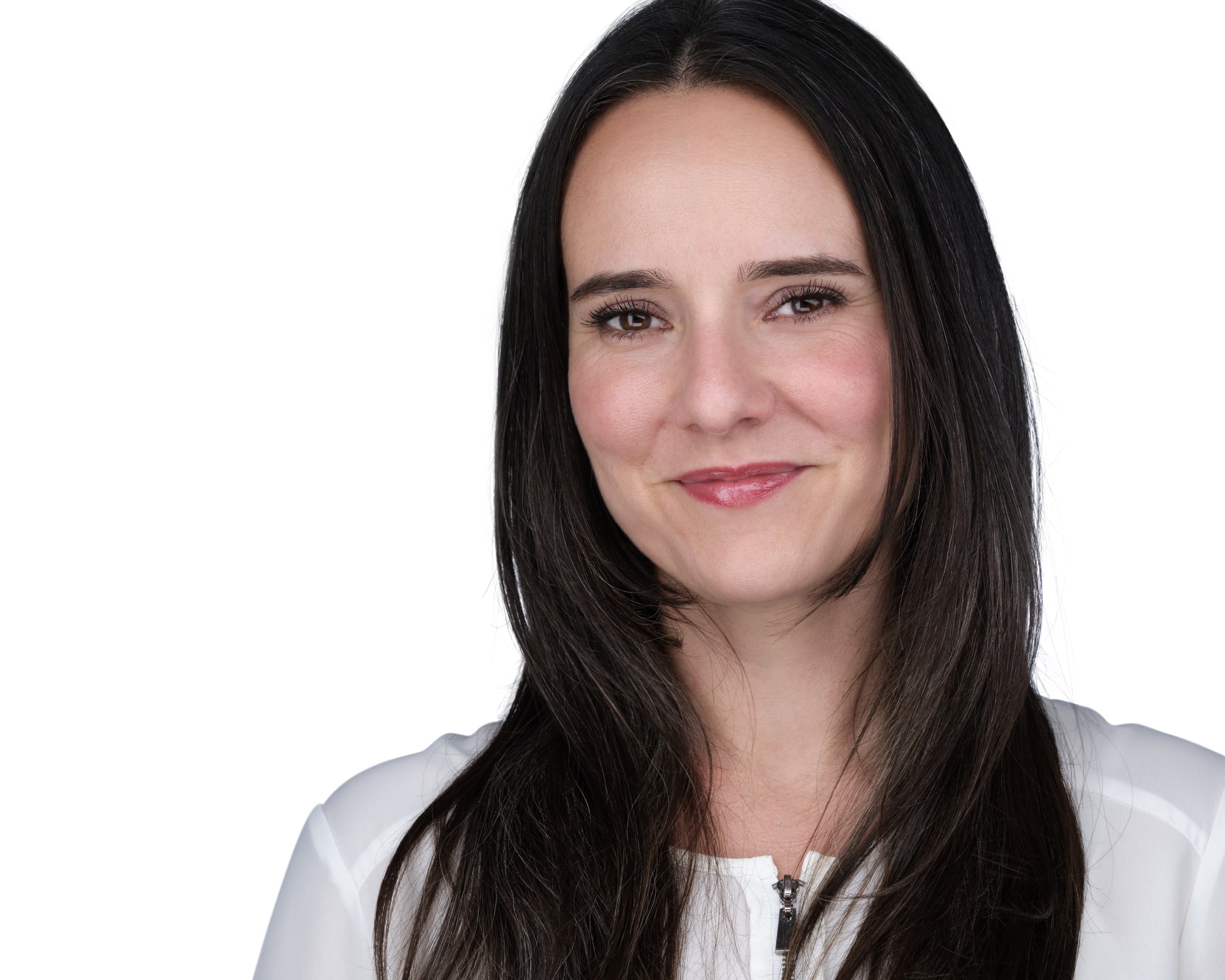 Close-up photo of a smiling woman with long dark hair, wearing a light-colored top and standing against a white background.