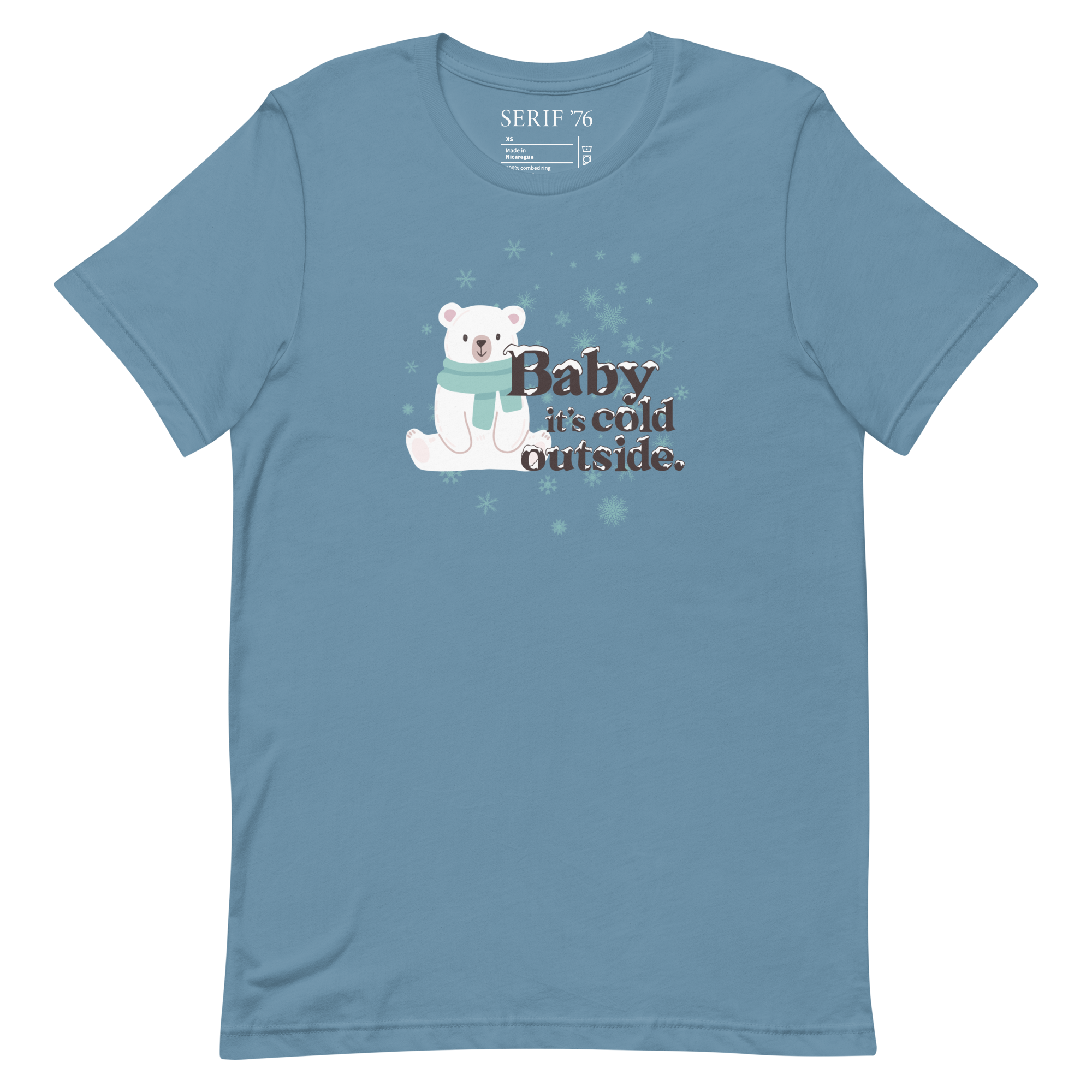 Dark teal colored short sleeved unisex t-shirt with an image of a polar bear in the snow with the phrase Baby It's Cold Outside in snow capped lettering.
