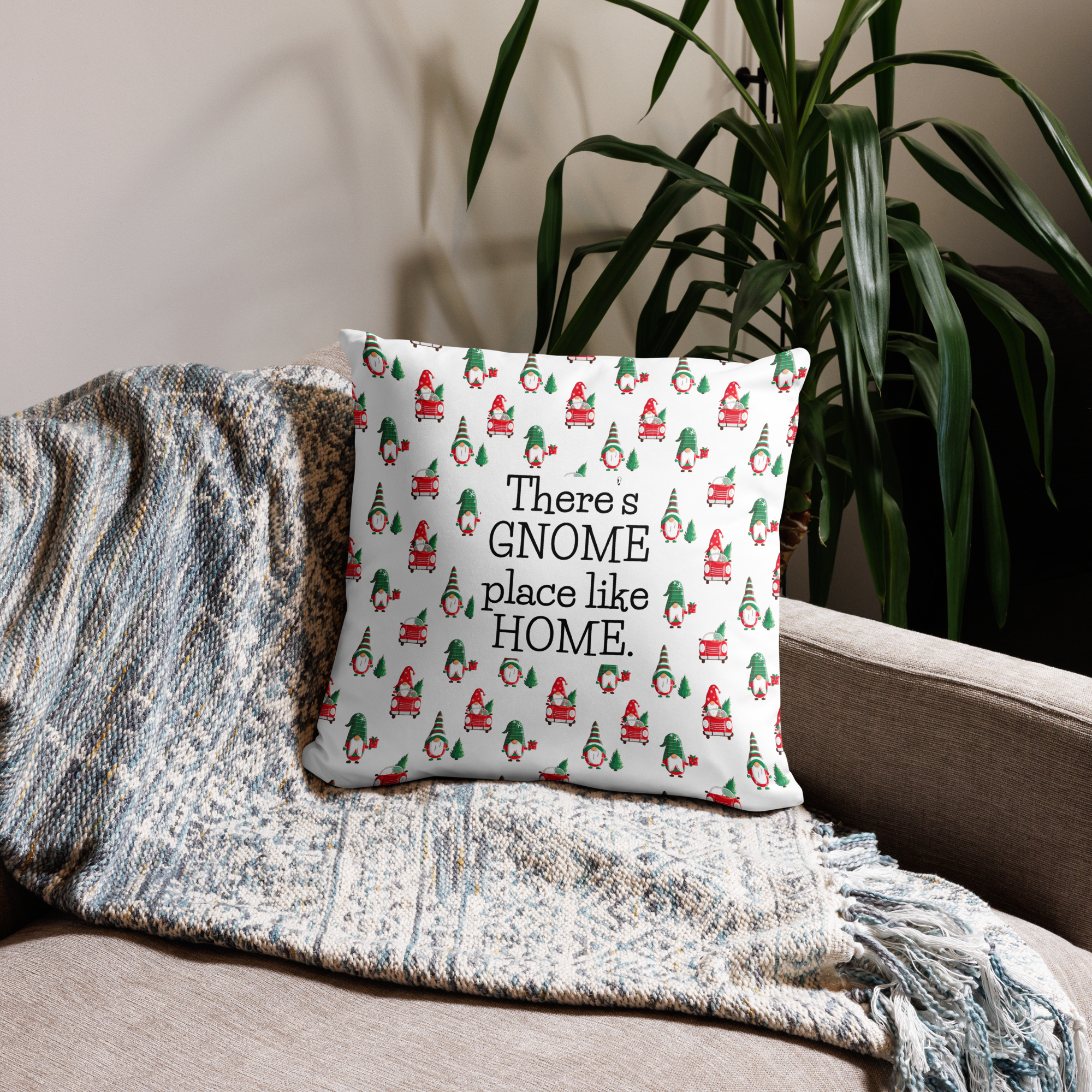 Lifestyle photo of a 18 x 18 inch throw pillow with the phrase There's Gnome Place Like Home with a festive pattern of Gnomes and Christmas Trees.