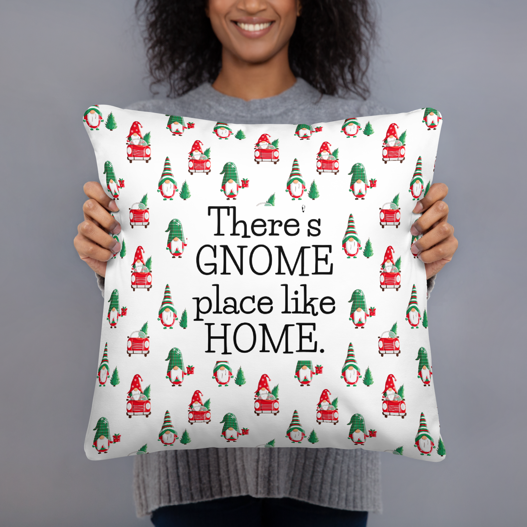 Woman holding a 18 x 18 inch throw pillow with the phrase There's Gnome Place Like Home with a festive pattern of Gnomes and Christmas Trees.