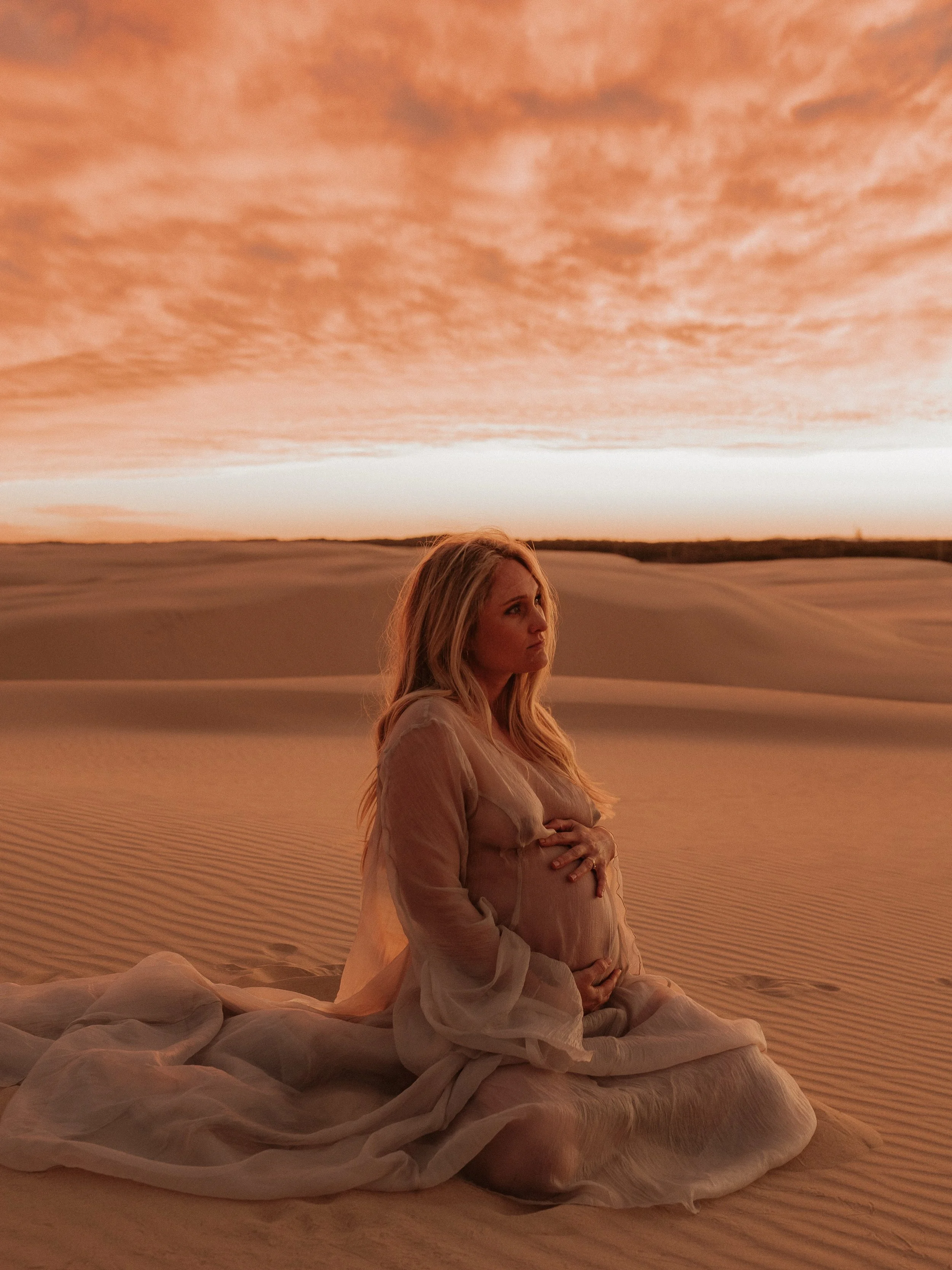The thing about motherhood is that it begins long before a baby arrives.

It begins in the waiting.

In the tiny kicks. The growing bump. The dreams of who they might become.

Standing amongst the Anna Bay sand dunes, with the wind catching every fol