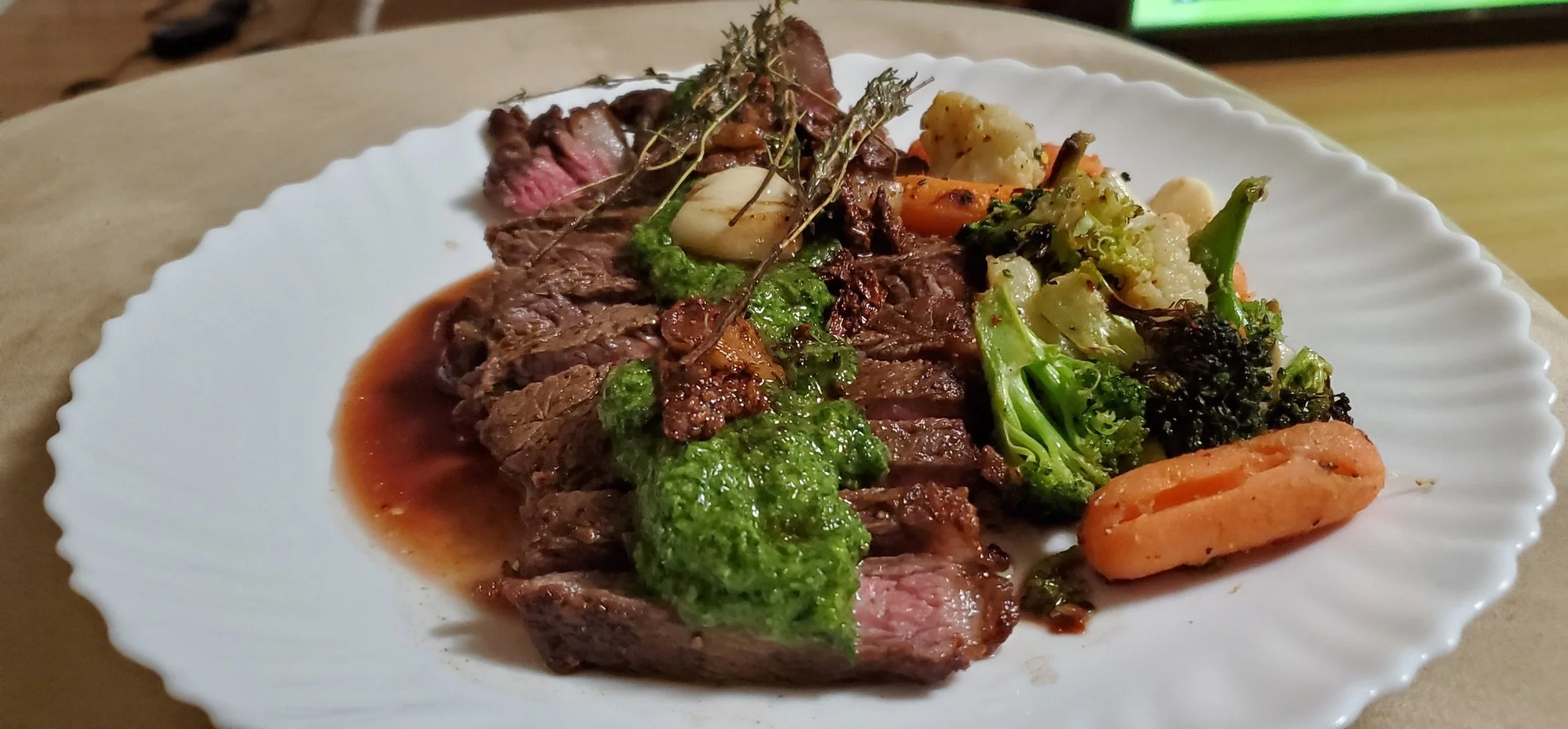 Canadian AAA Strip-loin with a Chimichurri alongside baked vegetables. 