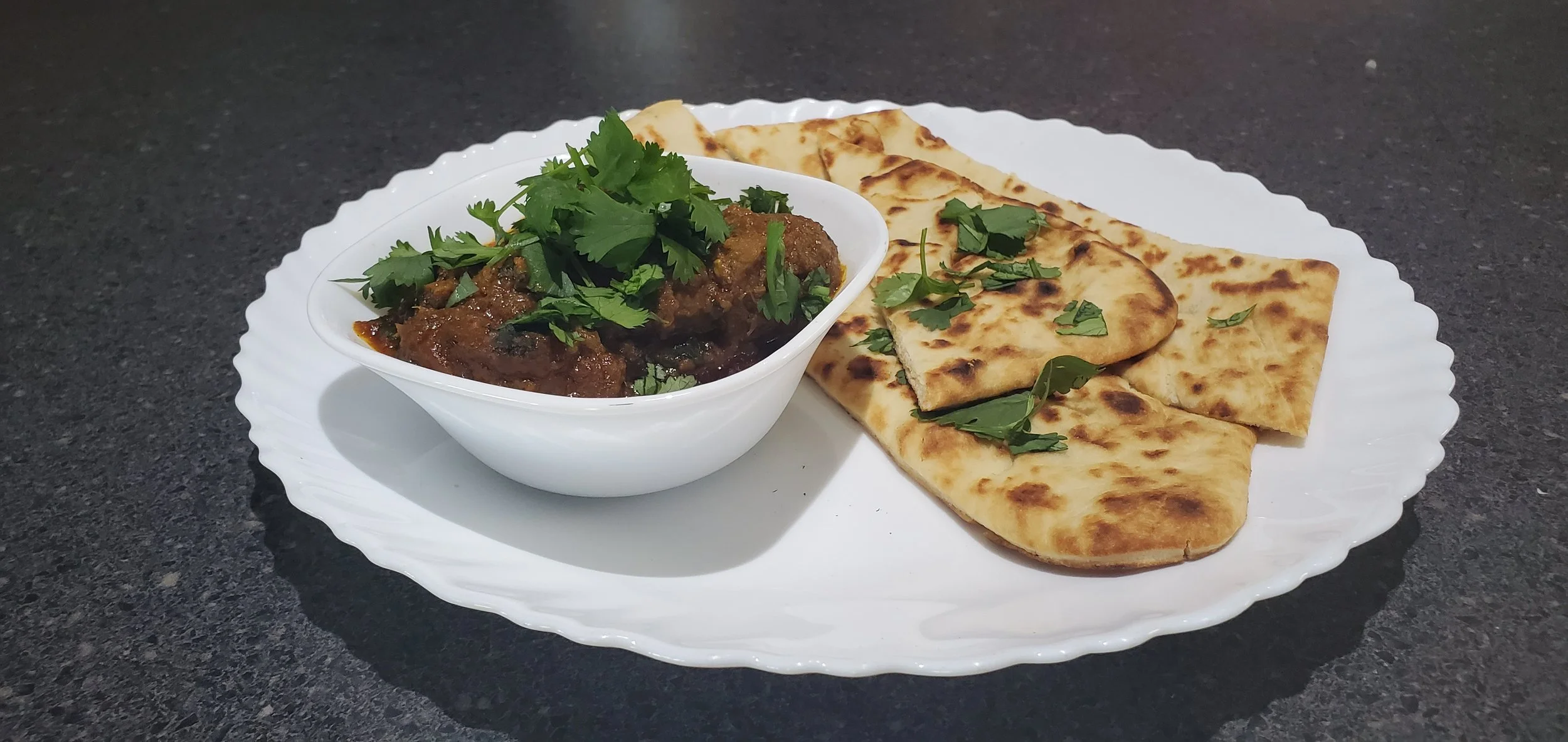 Indian Goat curry with a Goan twist served with a garlic naan. 