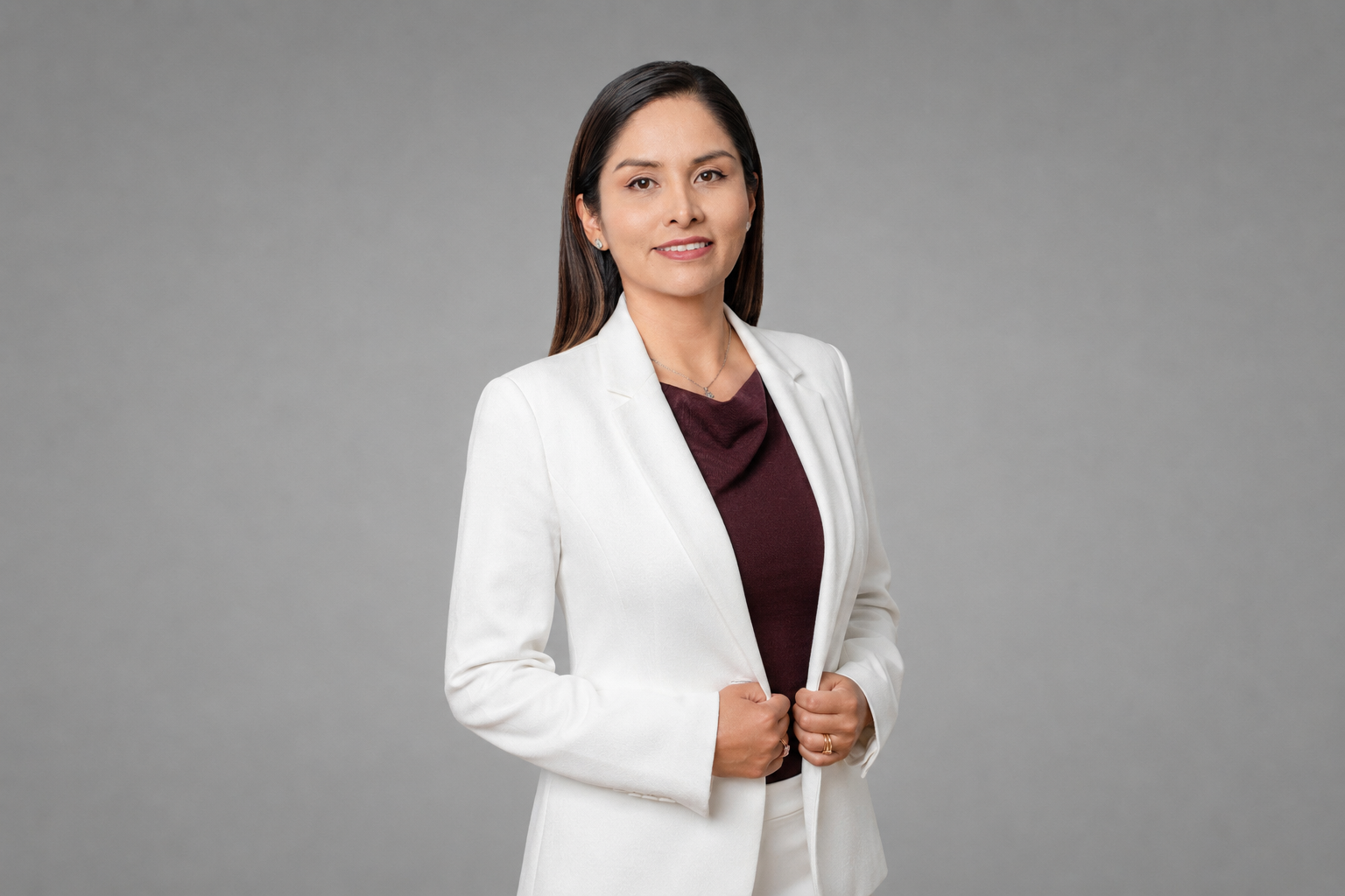 Confident woman smiling in white suit
